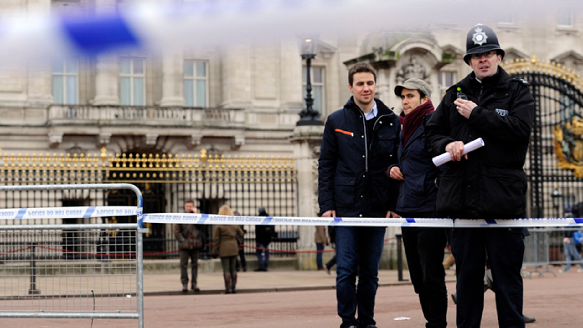 Feb. 3, 2013: A cornered off area containing knives, a hat and Taser wire outside Buckingham Palace in central London after a man armed with two knives was stunned by police.