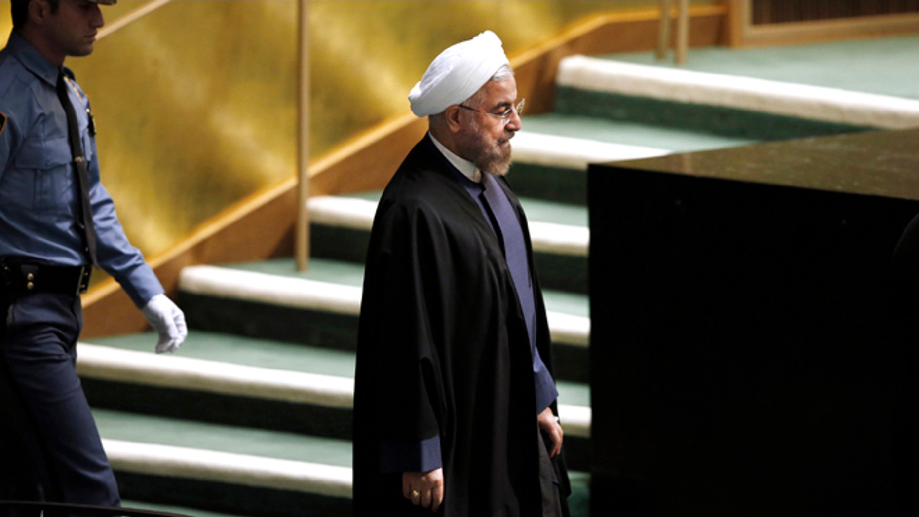 In this Thursday, Sept. 25, 2014 photo, President Hassan Rouhani of Iran walks in before addressing the 69th session of the United Nations General Assembly at U.N. headquarters.