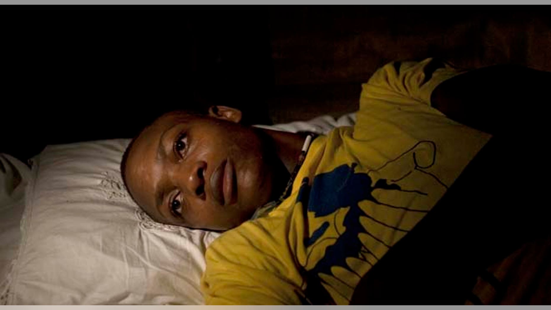 In this picture taken Sept. 3, 2011, an 18-year-old man who claims he was sexually abused by Uruguayan peacekeepers lies on his bed at his home in Port Salut, Haiti. A preliminary U.N. investigation has found no evidence for allegations that Uruguayan peacekeepers raped the 18-year-old man, Uruguay's Defense Ministry says, but the troops broke rules by having a civilian in their barracks. The alleged victim was snatched by a soldier outside the front gate of a U.N. base and was taken inside, according to the judge, Paul Tarte, and the alleged victim's mother. (AP Photo/Dieu Nalio Chery)