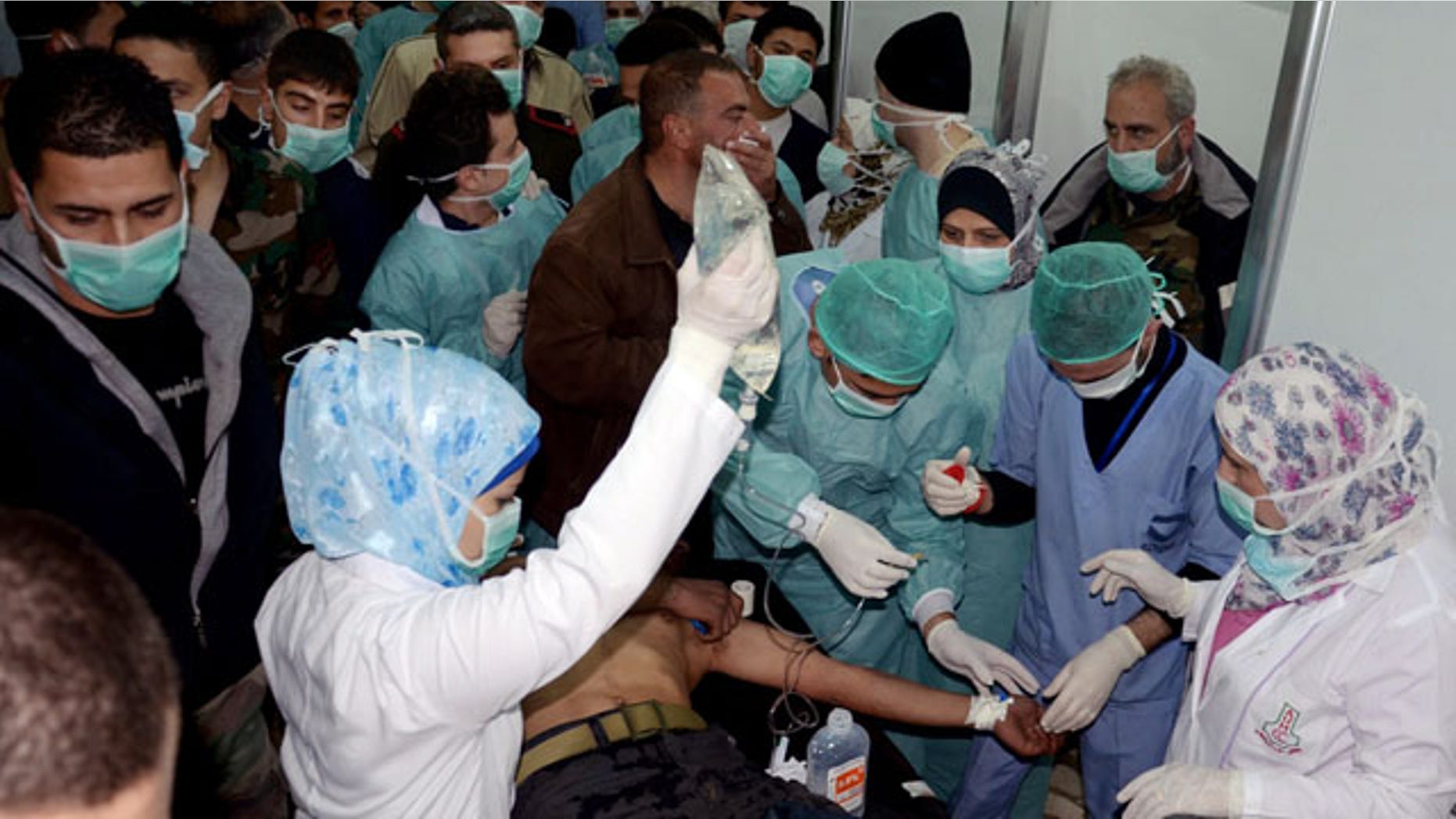 March 19, 2013: In tihs file photo provided by the Syrian official news agency SANA, a Syrian victim who suffered an alleged chemical attack at Khan al-Assal village receives treatment by doctors at a hospital in Aleppo.