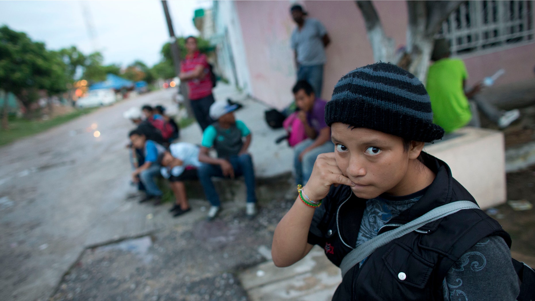 In this June 19, 2014 photo, a 14-year-old Guatemalan girl traveling alone waits for a northbound freight train along with other Central American migrants, in Arriaga, Chiapas state, Mexico. The United States has seen a dramatic increase in the number of Central American migrants crossing into its territory, particularly children traveling without any adult guardian. More than 52,000 unaccompanied children have been apprehended since October. (AP Photo/Rebecca Blackwell)