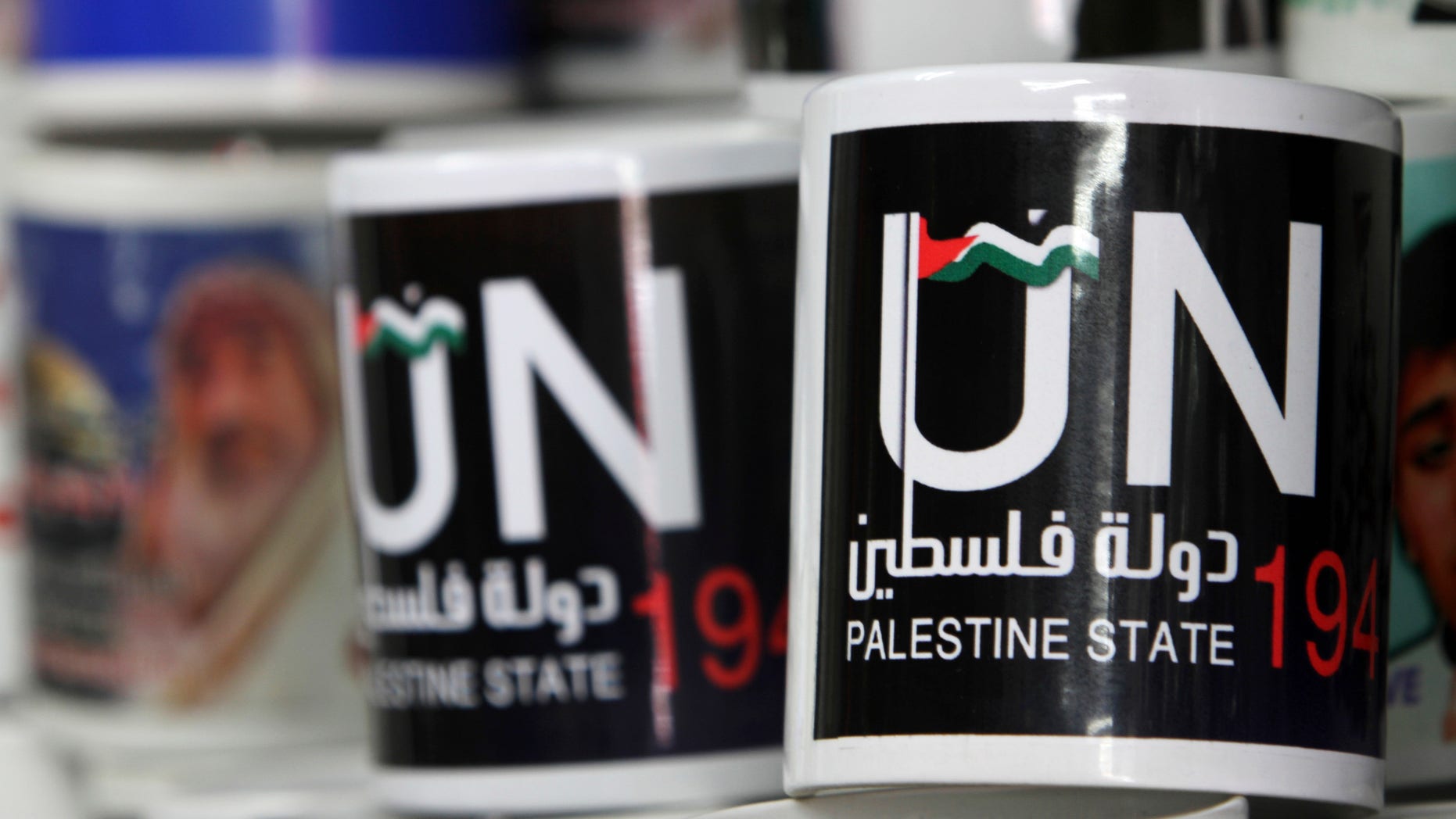 Cups designed as part of the campaign promoting the Palestinians' bid for statehood are displayed in a souvenirs shop in Gaza City, Tuesday, Sept. 13, 2011.