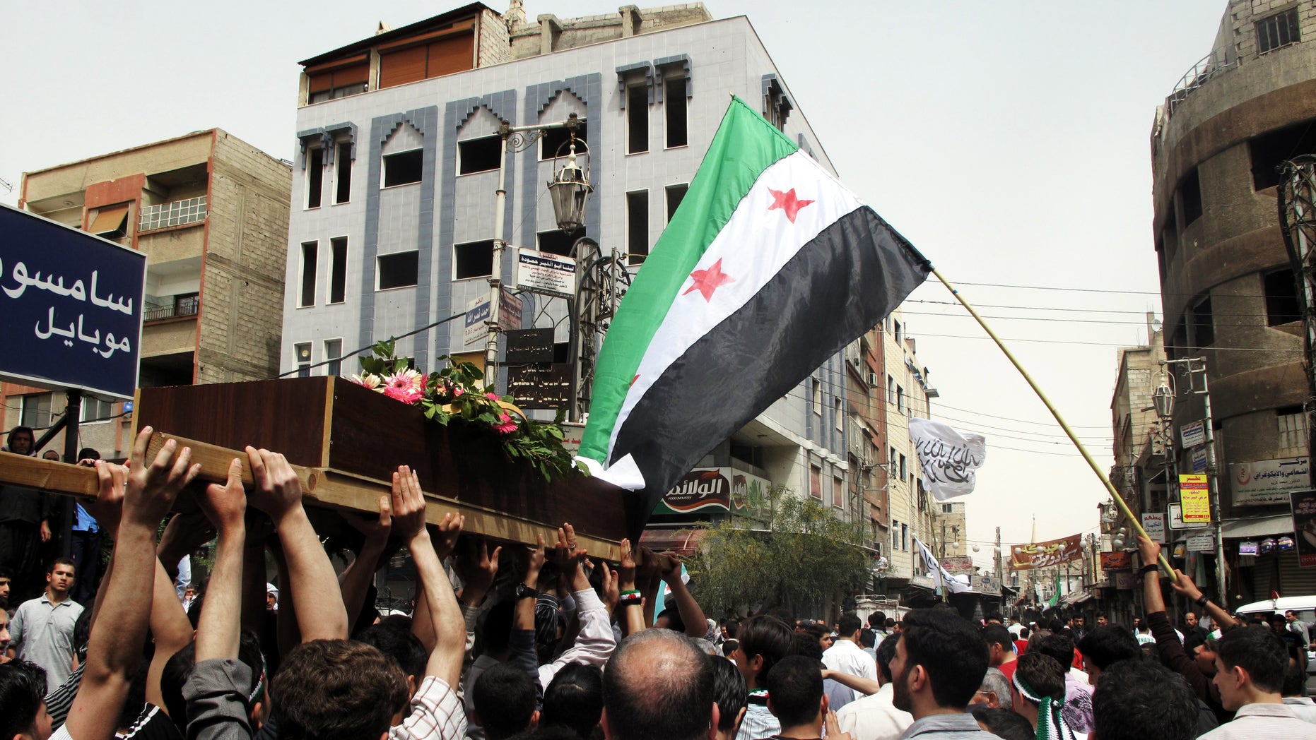 April 18, 2012: In this photo, Syrian mourners carry the body of Rama Saada, 9, who was shot by Syrian forces in Douma, Damascus, Syria.
