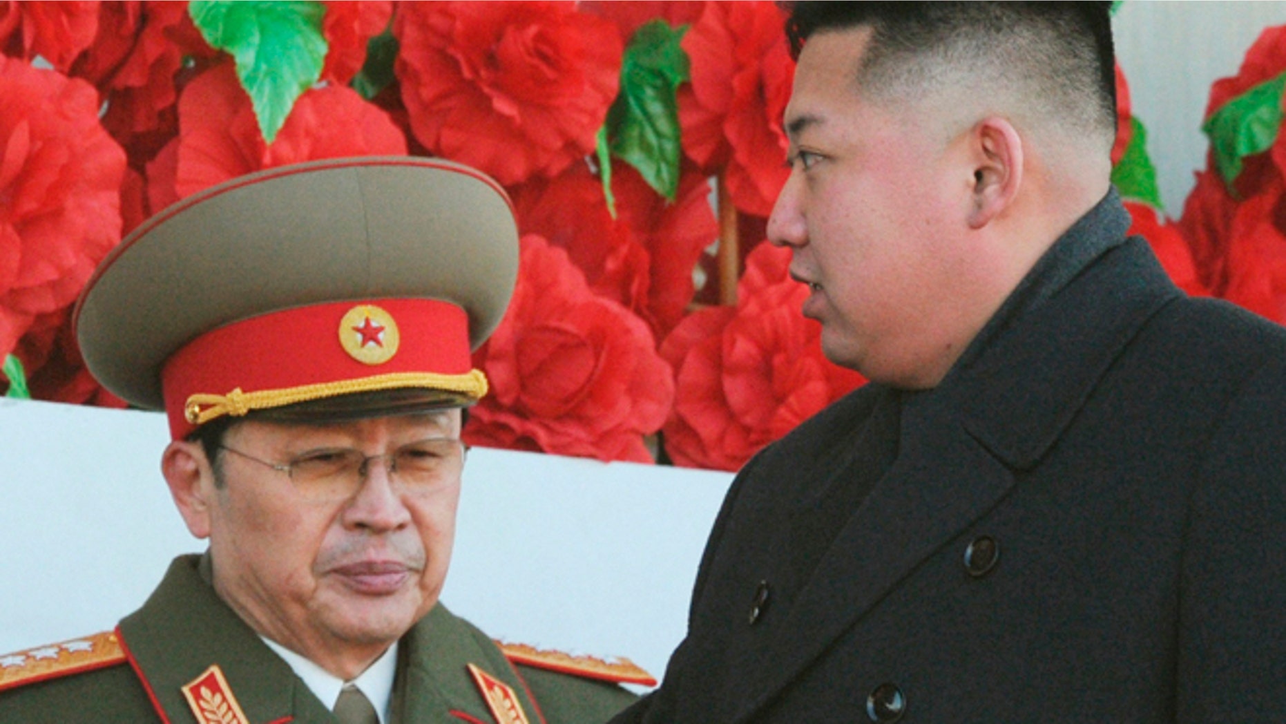 FILE: North Korean leader Kim Jong Un is flanked by his uncle Jang Song Thaek at a military parade to mark the birth anniversary of the North's late leader Kim Jong-il in Pyongyang.