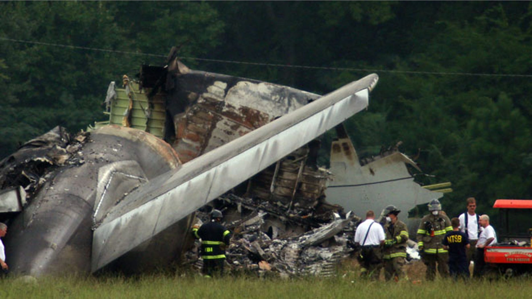 Aug 15, 2013: NTSB investigators work around the tail section of the UPS cargo plane that crashed on approach to the Birmingham-Shuttlesworth International Airport in Birmingham, Ala.
