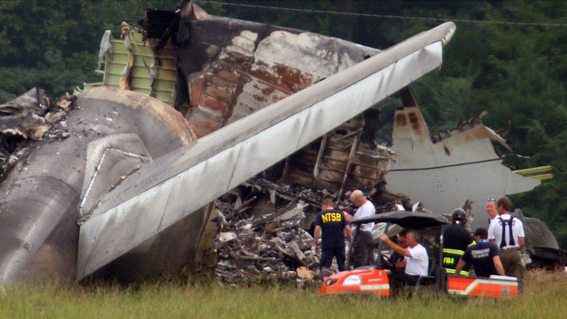 Aug 15, 2013: NTSB investigators work around the tail section of the UPS cargo plane that crashed on approach to the Birmingham-Shuttlesworth International Airport in Birmingham, Ala.