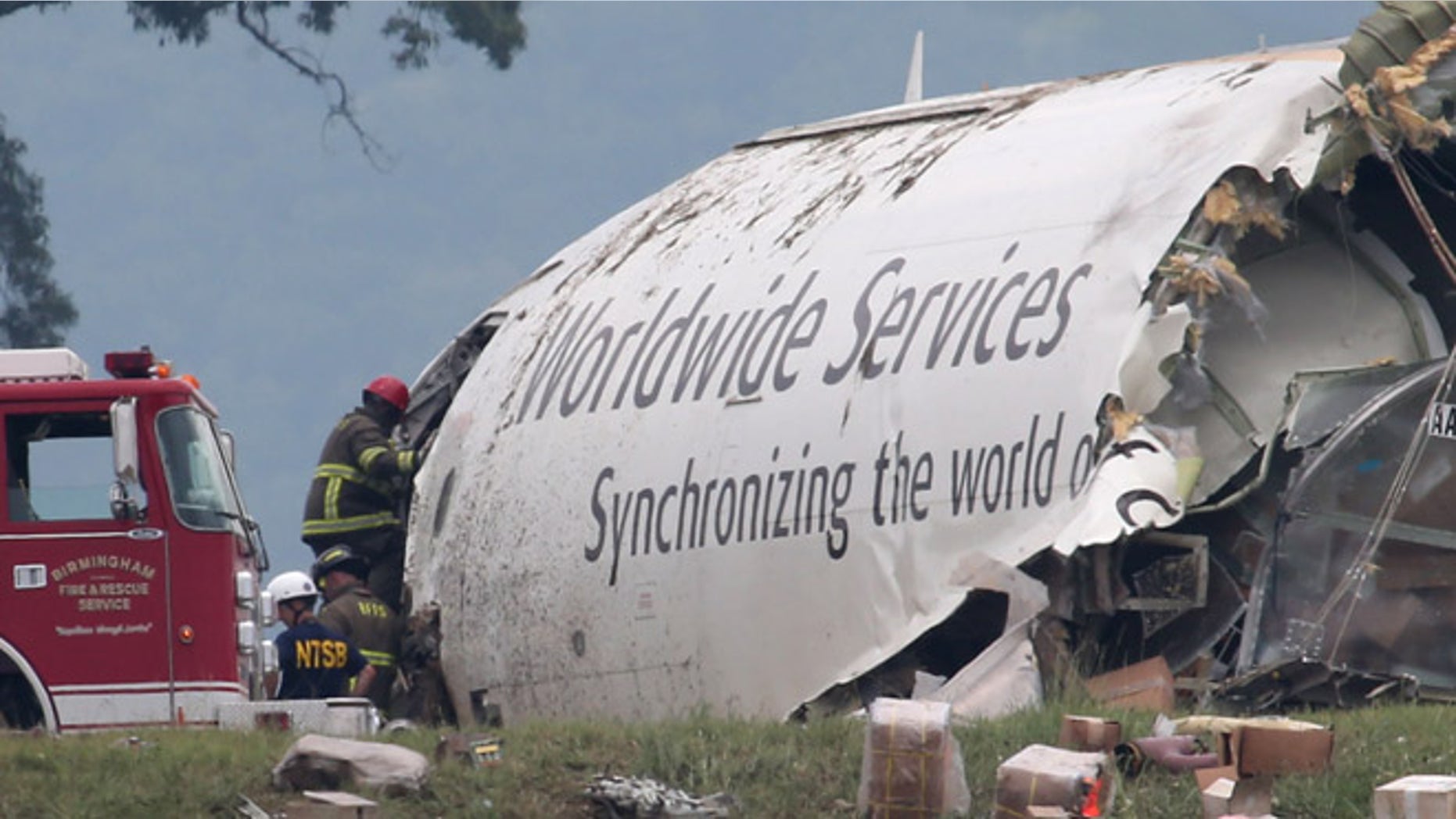 Aug. 14, 2013: Investigators work near a section of debris of a UPS Airbus A300 cargo plane after it crashed on approach at Birmingham-Shuttlesworth International Airport in Birmingham, Ala.