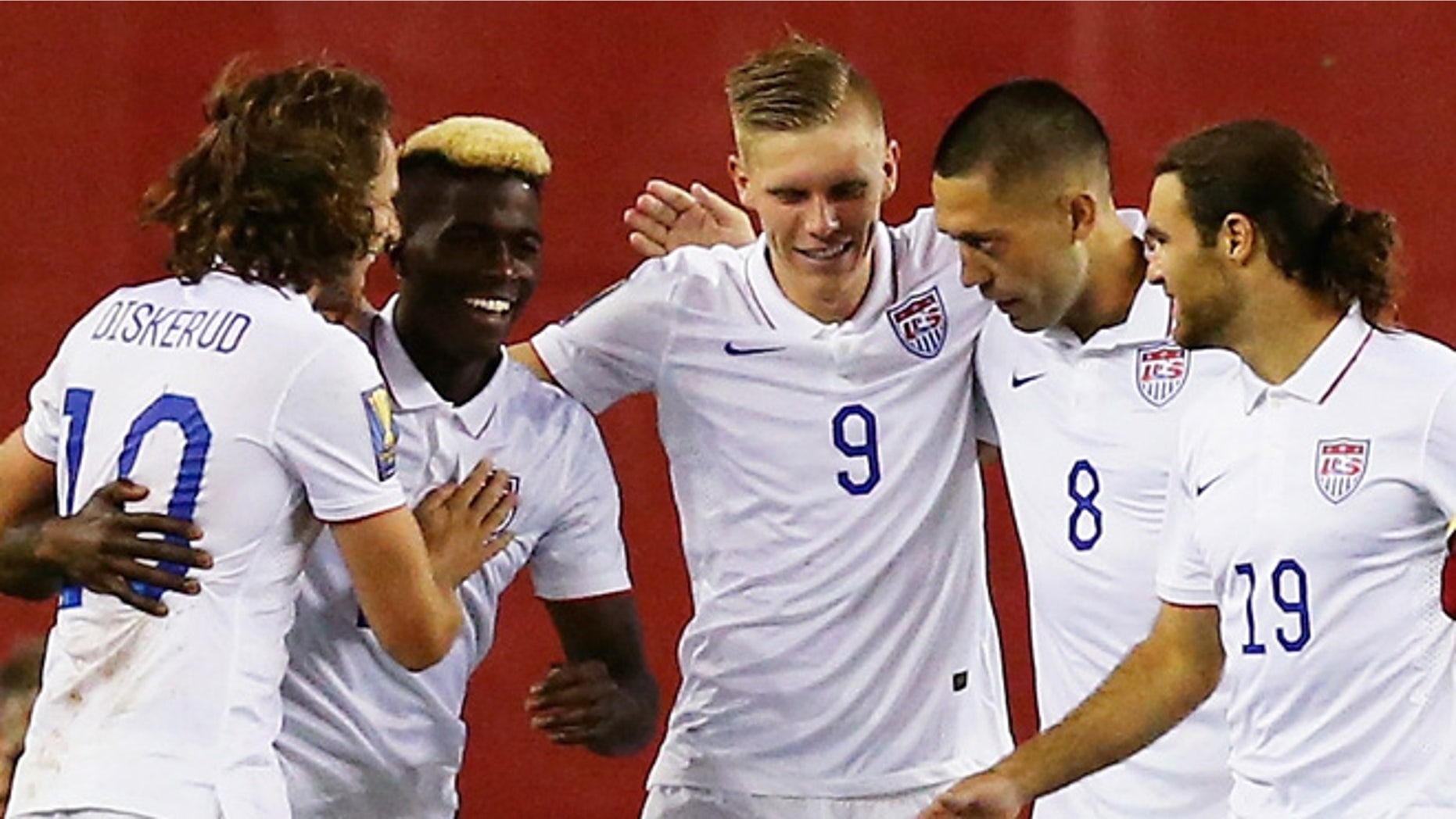FOXBORO, MA - JULY 10: Teammates congratulate Clint Dempsey #8 of United States after he scored a goal as Frantz Bertin #6 of Haiti, right, disputes the call during the 2015 CONCACAF Gold Cup Group A match between United States and Haiti at Gillette Stadium on July 10, 2015 in Foxboro, Massachusetts. (Photo by Maddie Meyer/Getty Images)