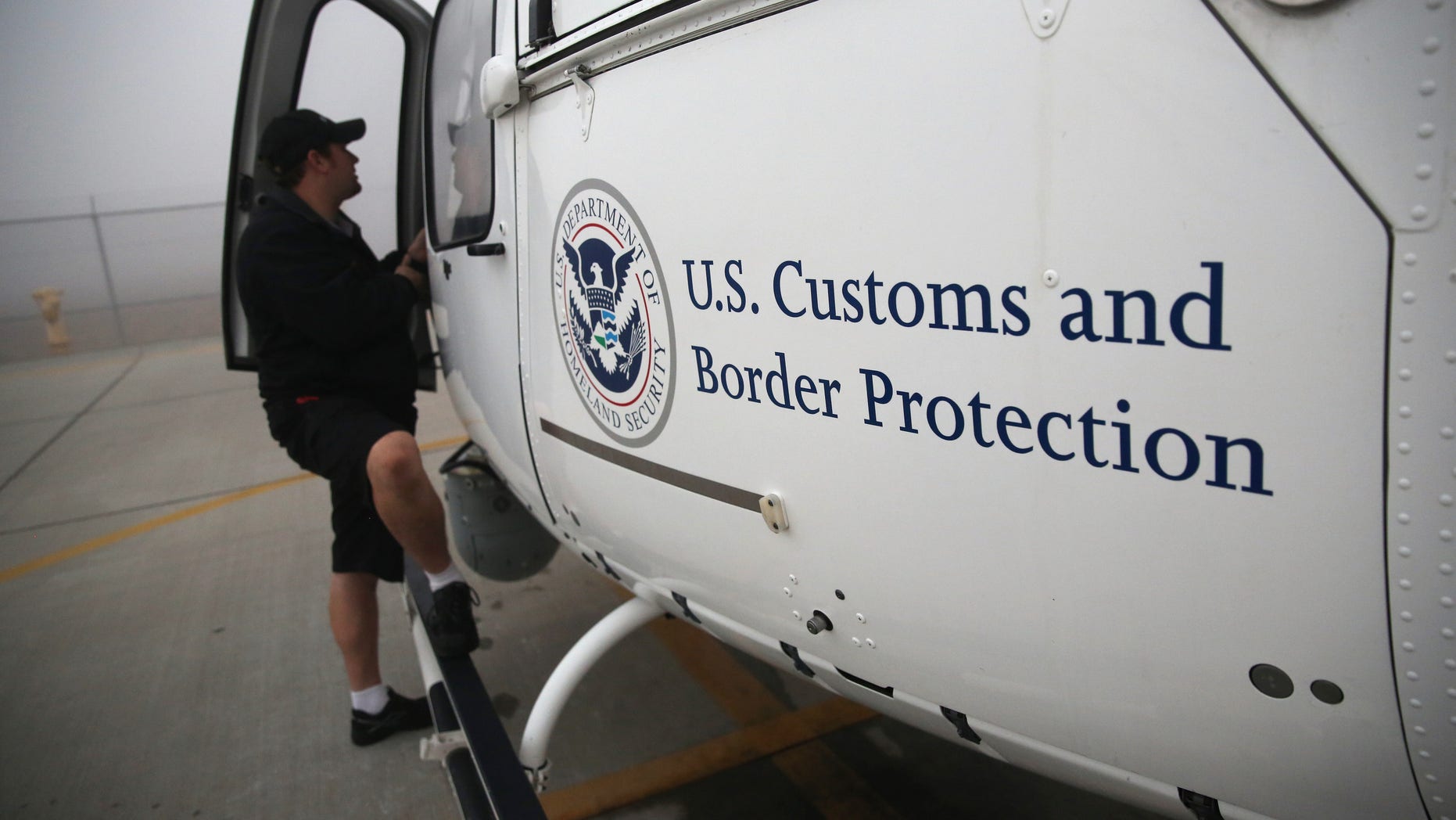 SAN DIEGO, CA - OCTOBER 01: A maintenance worker prepares a U.S. Office of Air and Marine (OAM) helicopter for takeoff to patrol the U.S.-Mexico border on October 1, 2013 in San Diego, California. OAM helicopters support the U.S. Border Patrol as well as Immigration and Customs Enforcement (ICE), personnel protecting border areas. While much of the Federal Government has closed down, personnel considered essential, such as border agents, remain working. (Photo by John Moore/Getty Images)