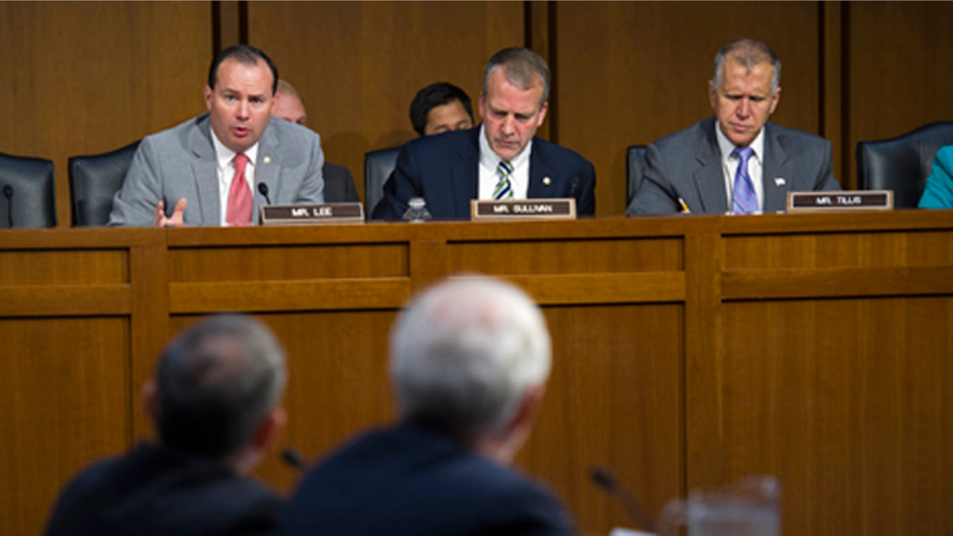 Sept. 17, 2015: Adm. Harry Harris, Jr., US Navy Commander, U.S. Pacific Command and Assistant Defense Secretary for Asian and Pacific Security Affairs David Shear, foreground, are questioned on Capitol Hill in Washington by Senate Armed Services Committee member Sen. Mike Lee, R-Utah, left, as members Sen. Daniel Sullivan, R-Alaska, center, and Sen. Thom Tillis, R-N.C., right, listen during the committee's hearing on maritime security strategy in the Asia-Pacific region. (AP Photo/Cliff Owen)