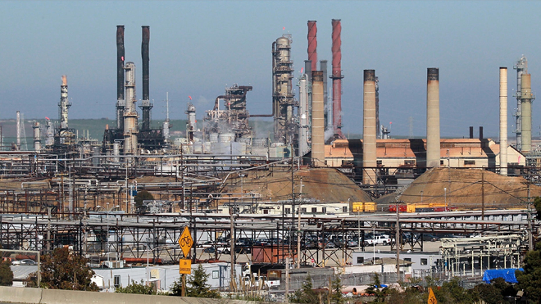A car drives past the Chevron refinery on January 25, 2011 in Richmond, California. (Photo by Justin Sullivan/Getty Images)