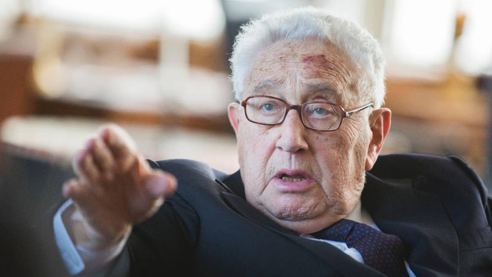 FILE - In a June 11, 2013 file photo, former US Secretary of State Henry Kissinger gestures during a birthday reception for his 90th birthday in Berlin, Germany. According to declassified government documents posted online Wednesday, Oct. 1, 2014, Kissinger ordered contingency plans drawn up nearly 40 years ago to attack Cuba, incensed over the small island's deployment of troops to Angola. (AP Photo/Gero Breloer, Pool)