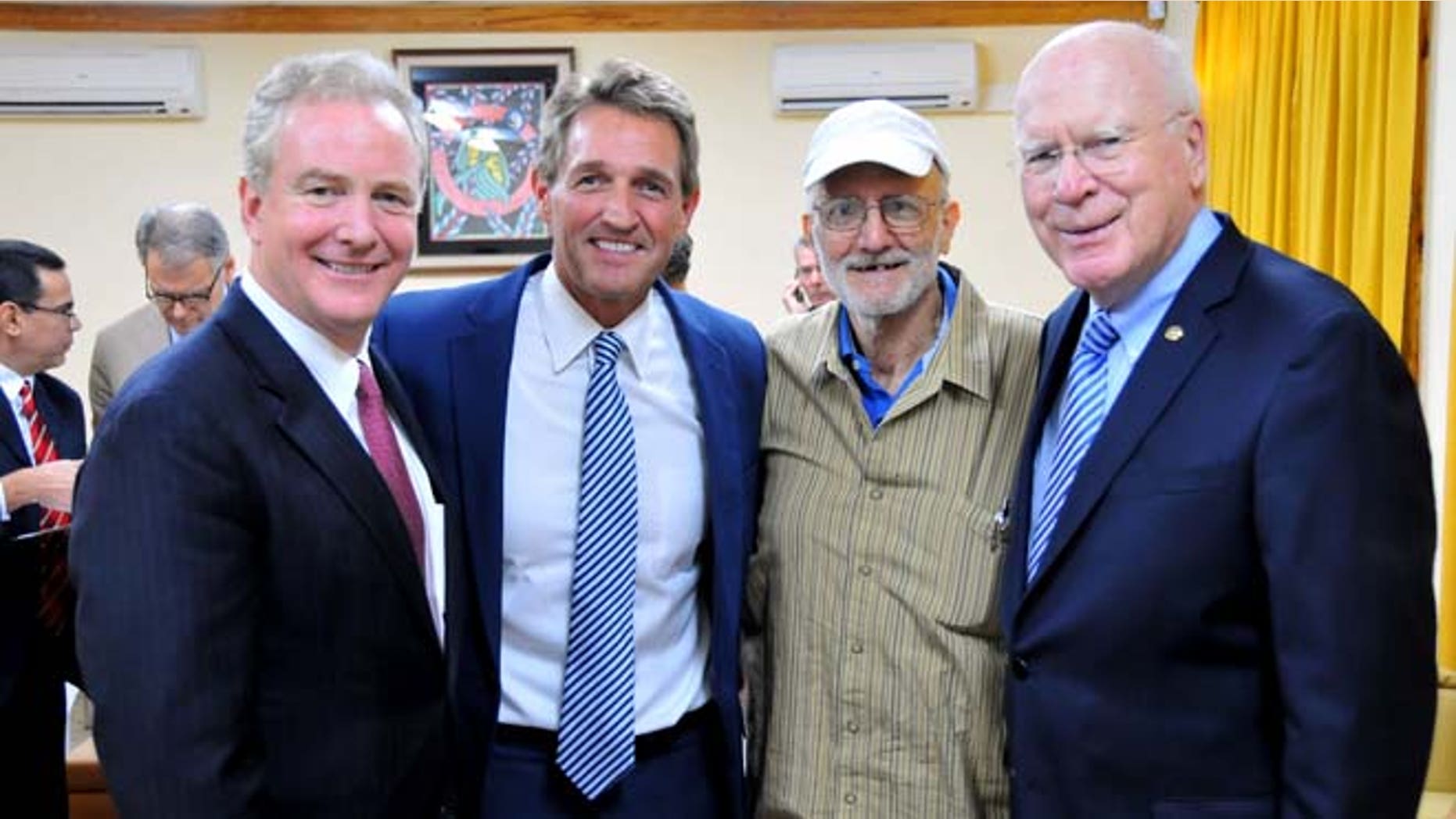 This Wednesday, Dec. 17, 2014 photo shows Alan Gross, second from right, with, from left, Rep. Chris Van Hollen, D-Md., Sen. Jeff Flake, R-Ariz., and Sen. Patrick Leahy, D-Vt. in Havana, Cuba.