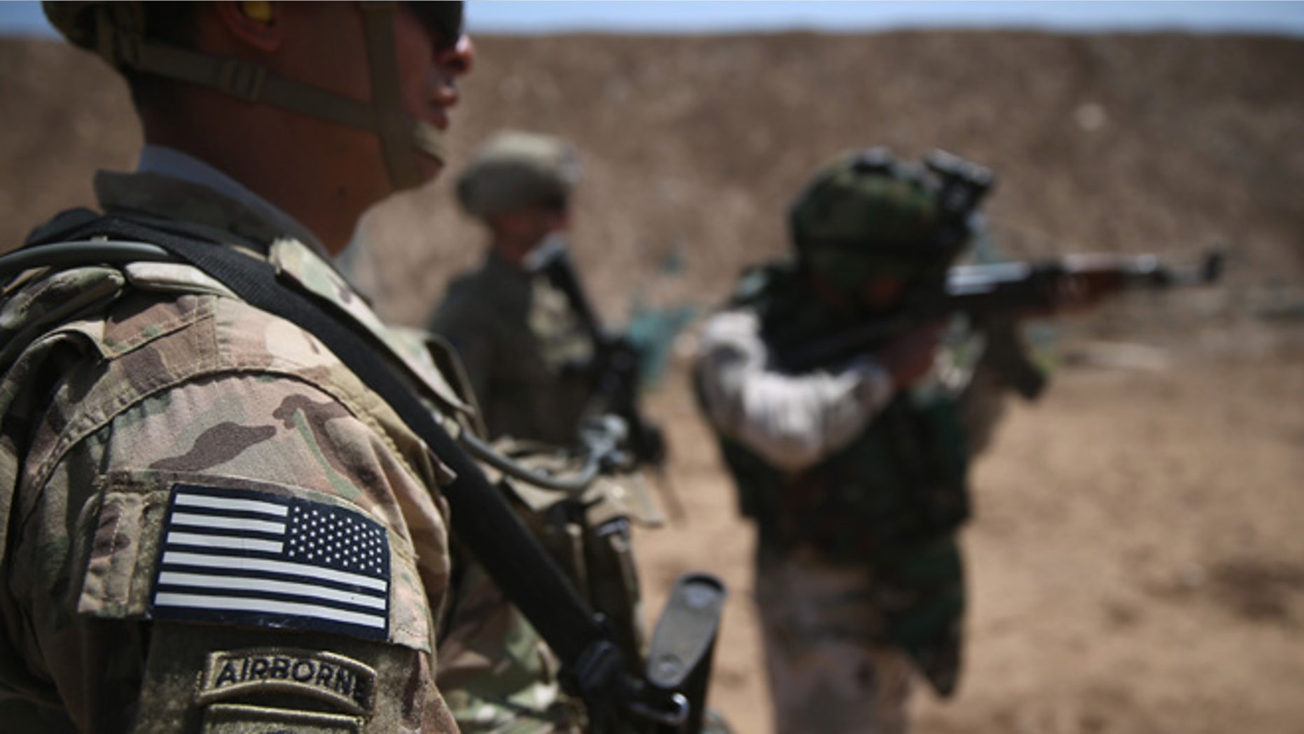 TAJI, IRAQ - APRIL 12: U.S. Army trainers watch as an Iraqi recruit fires at a military base on April 12, 2015 in Taji, Iraq. U.S. forces, currently operating in 5 large bases throught the country, are training thousands of Iraqi Army combat troops, trying to rebuild a force they had origninally trained before the U.S. withdrawal from Iraq in 2010. Members of the U.S. Army's 5-73 CAV, 3BCT, 82nd Airborne Division are teaching members of the newly-formed 15th Division of the Iraqi Army, as the Iraqi government launches offensives to try to recover territory lost to ISIS last year. (Photo by John Moore/Getty Images)