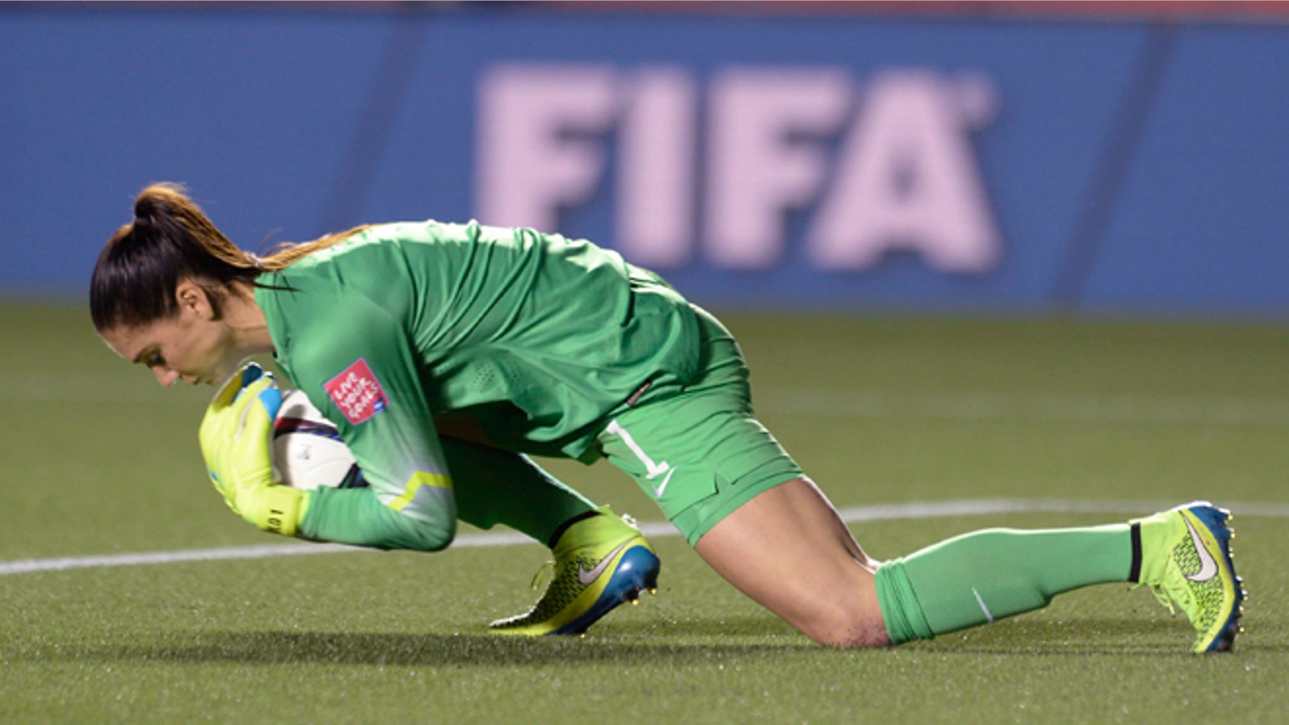 U.S. keeper Hope Solo makes a save against China in the World Cup soccer tournament, Friday, June 26, 2015, in Ottawa.