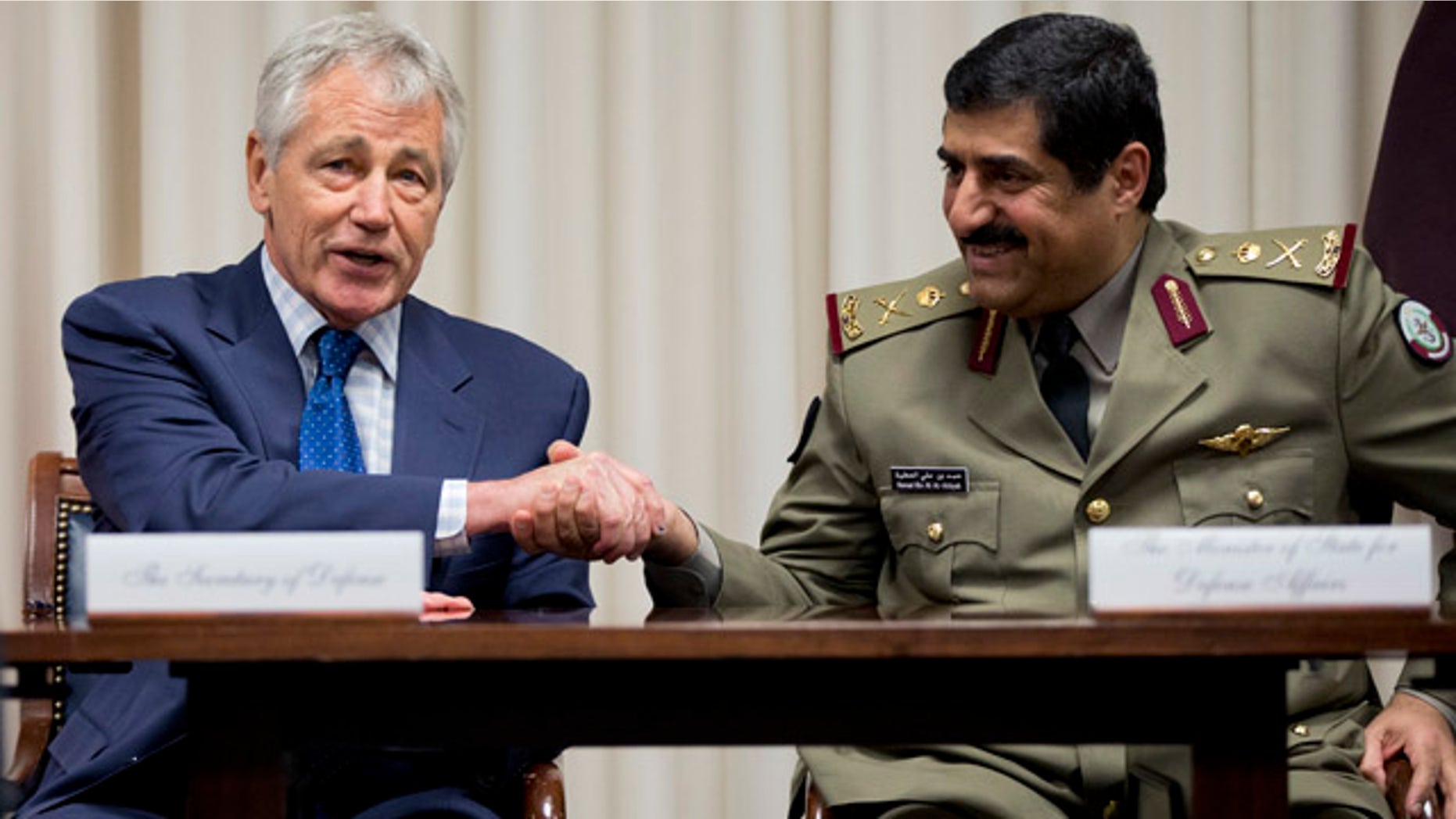 July 14, 2014: Defense Secretary Chuck Hagel, left, shakes hands with Qatari Defense Minister Hamad bin Ali al-Attiyah during a signing ceremony at the Pentagon. (AP Photo/Manuel Balce Ceneta)