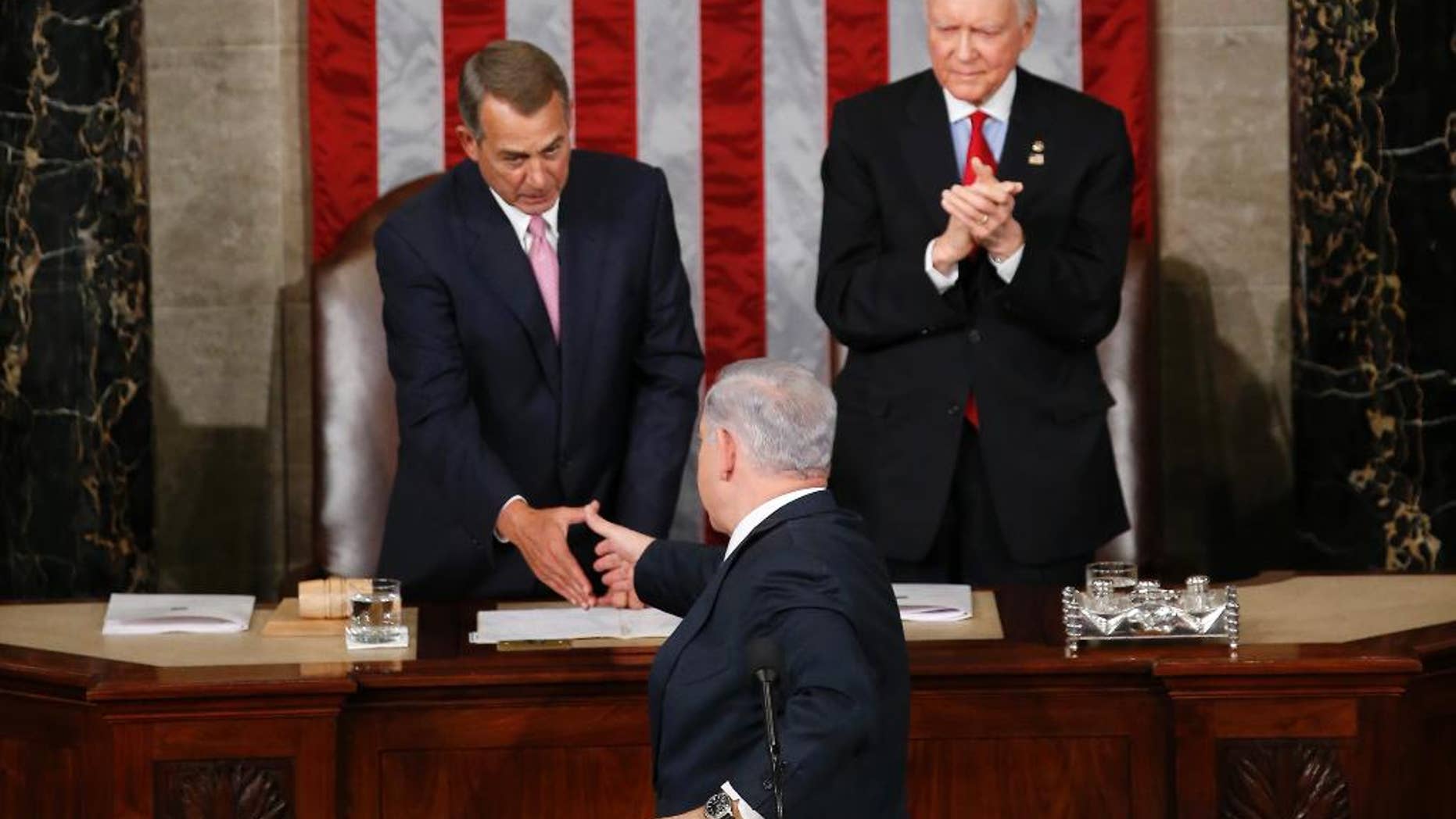 Israeli Prime Minister Benjamin Netanyahu turns and shake hands with House Speaker John Boehner of Ohio hand after addressing a joint meeting of Congress on Capitol Hill in Washington, Tuesday, March 3, 2015. In a speech that stirred political intrigue in two countries, Netanyahu told Congress that negotiations underway between Iran and the U.S. would "all but guarantee" that Tehran will get nuclear weapons, a step that the world must avoid at all costs. Sen. Orrin Hatch, R-Utah applauds at right. (AP Photo/Andrew Harnik)