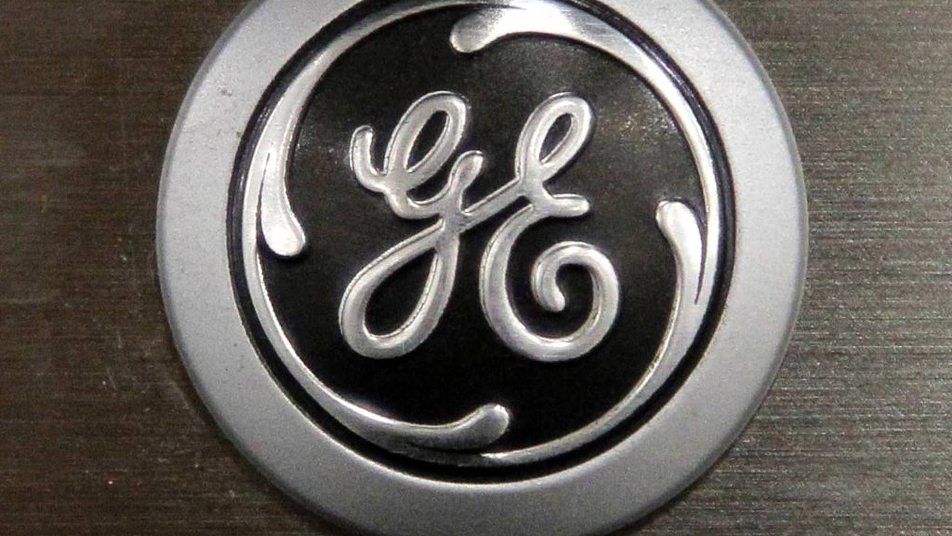 FILE - In this Monday, Sept. 10, 2012 file photo a General Electric logo is seen on a kitchen stove at a Lowe's store in Framingham, Mass. Industrial companies such as General Electric, Honeywell and Caterpillar, which make expensive equipment that other companies need to buy in order to grow, have been posting strong results in recent weeks and telling investors that orders are strong. (AP Photo/Steven Senne, File)