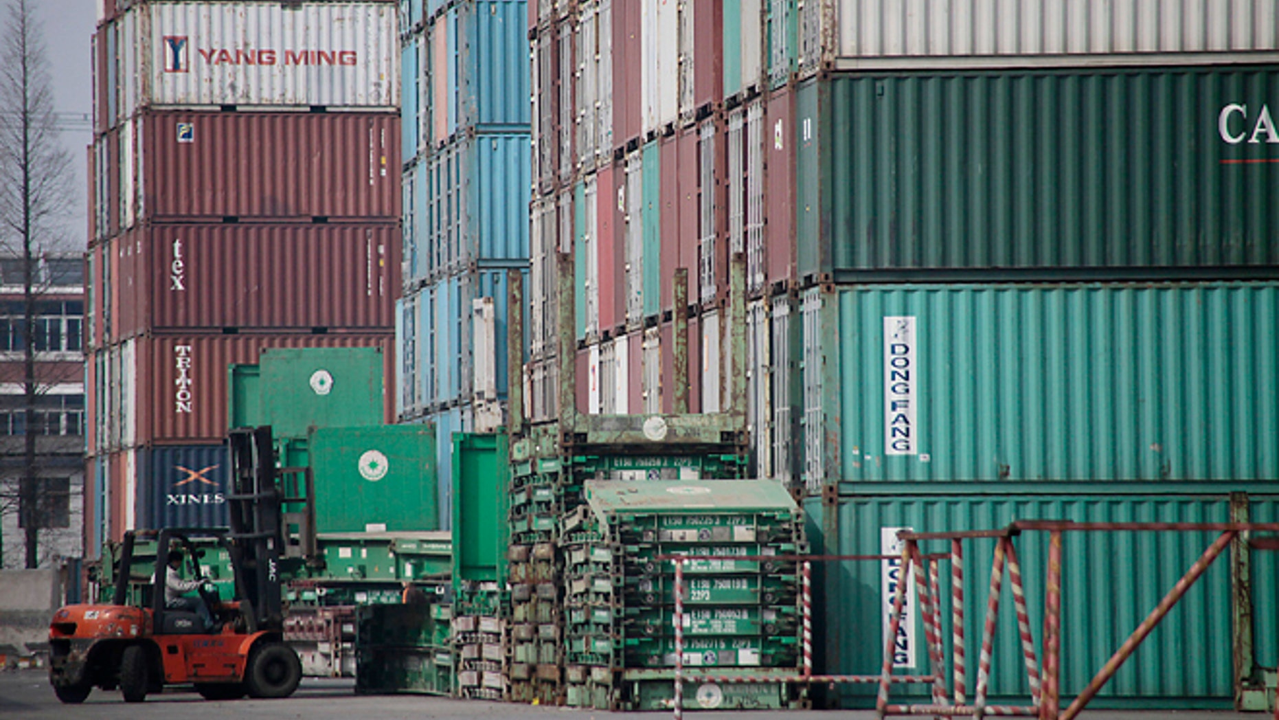 FILE - In this file photo taken March 2, 2011, a forklift arranges the shipping containers near a port in Shanghai. U.S. manufacturers have grown more competitive over the past decade compared with factories in China, Brazil and most of the world's other major economies. So says a new private study issuing a report Friday April 25, 2014, which found that rising wages and higher energy costs have diminished China's long-standing edge over the United States. (AP Photo/Eugene Hoshiko, File)