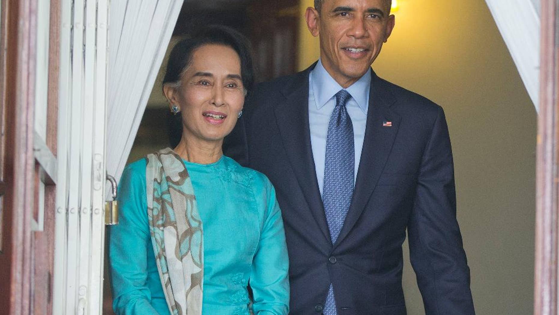 FILE - In this Nov. 14, 2014 file photo, President Barack Obama walks with Myanmar's opposition leader Aung San Suu Kyi for their joint news conference at her home in Yangon, Myanmar. Human rights advocates and some lawmakers say the United States is sending the wrong signal by opening the door for broader cooperation with Myanmar’s widely criticized military just weeks after President Barack Obama assured opposition leader Aung San Suu Kyi that closer ties weren’t going to happen soon. (AP Photo/Pablo Martinez Monsivais, File)