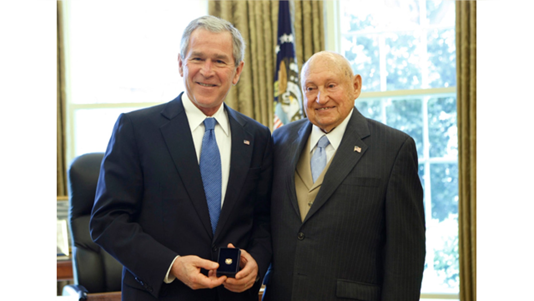 FILE - In this April 15, 2008, file photo, then President George W. Bush presents the Lifetime President's Volunteer Service Award to Chick fil-A Inc. founder S. Truett Cathy in the Oval Office of the White House in Washington. (AP Photo/Gerald Herbert, File)