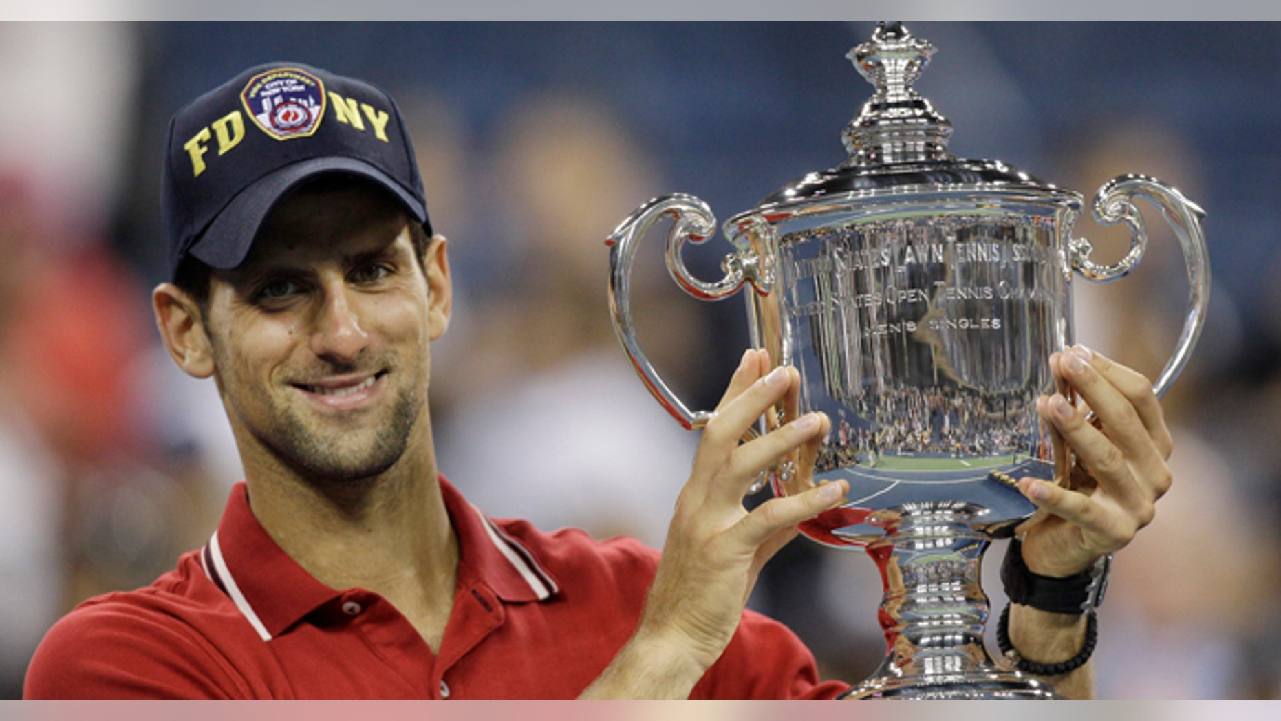 Novak Djokovic of Serbia poses with the trophy after winning the men's championship match against Rafael Nadal of Spain at the U.S. Open tennis tournament in New York, Monday, Sept. 12, 2011. (AP Photo/Matt Slocum)