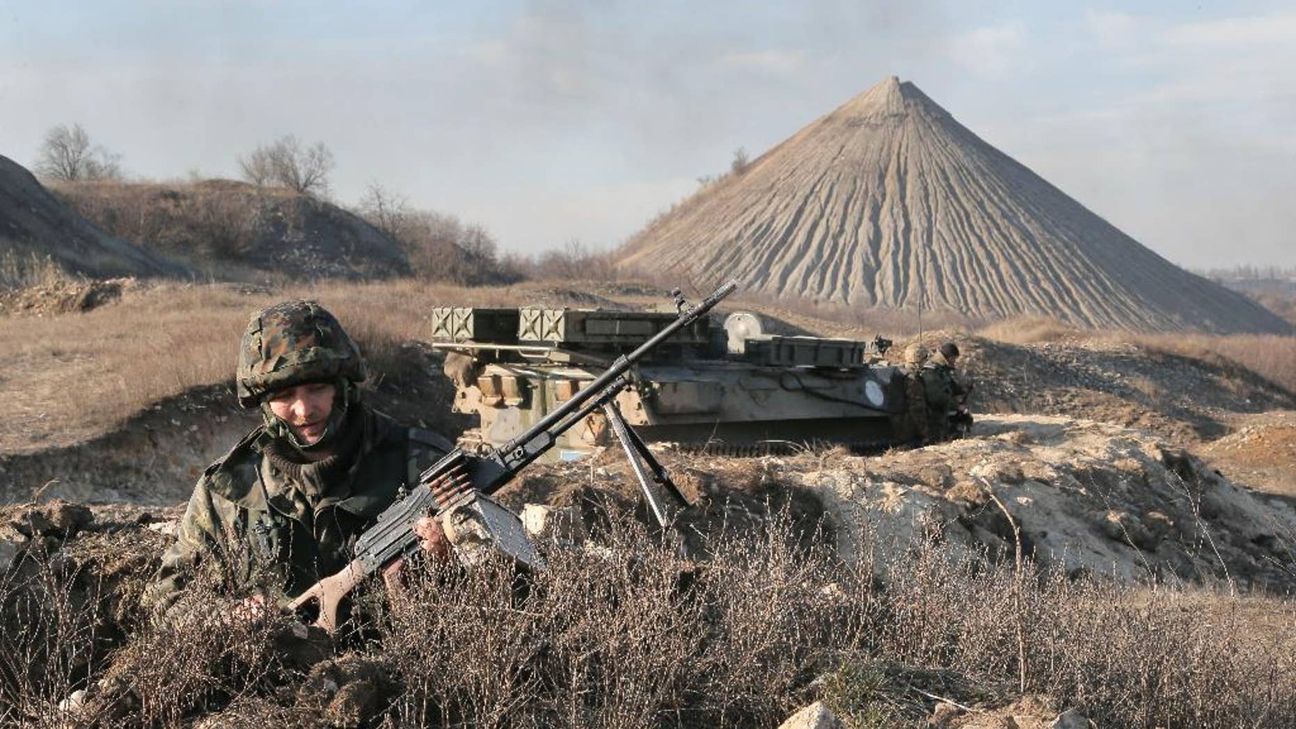 FILE - In this March 11, 2015, file photo, a Ukrainian serviceman takes position at the front line outside Kurahovo, in the Donetsk region of Ukraine. The United States now sees the Ukrainian rebels as a Russian force. American officials briefed on intelligence from the region say Russia has significantly deepened its command and control of the militants in eastern Ukraine in recent months, leading the U.S. to quietly introduce a new term: "combined Russian-separatist forces." (AP Photo/Efrem Lukatsky, File)