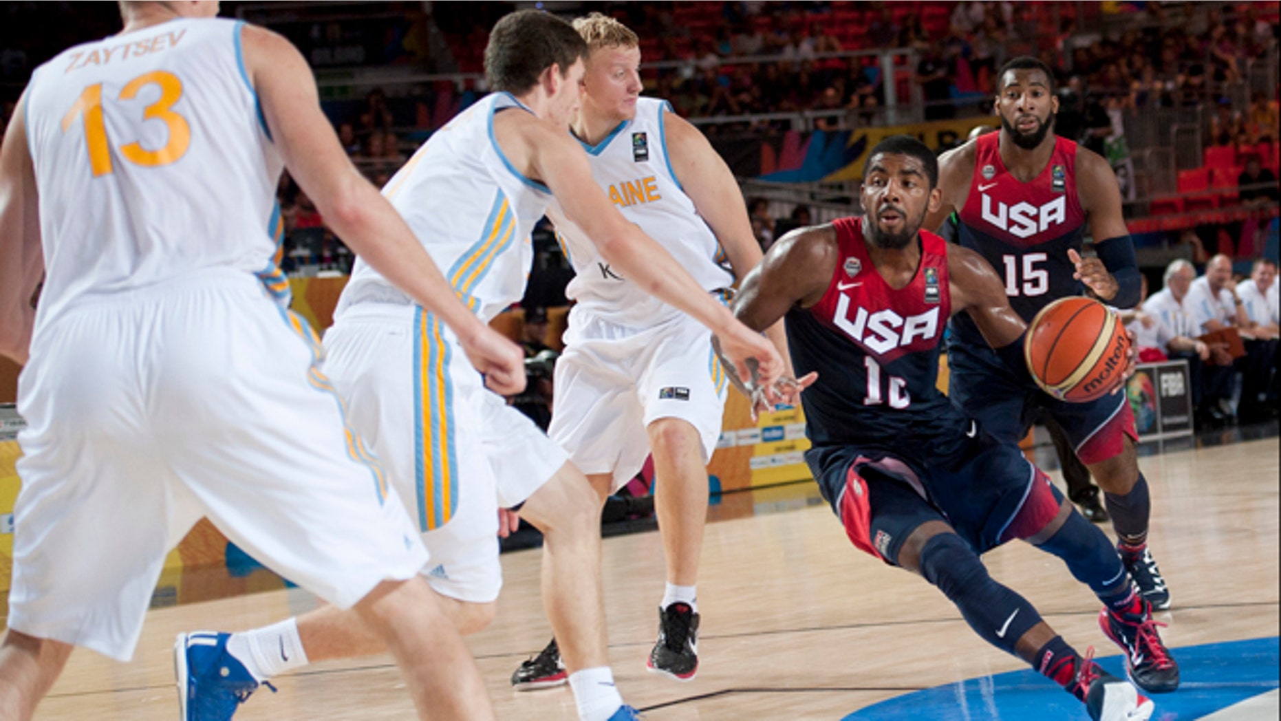Kyrie Irving of the US goes for the basket between Ukraine players during the Group C Basketball World Cup match, in Bilbao northern Spain, Thursday, Sept. 4, 2014. The 2014 Basketball World Cup competition take place in various cities in Spain from Aug. 30 through to Sept. 14. United States won 95-71. (AP Photo/Alvaro Barrientos)