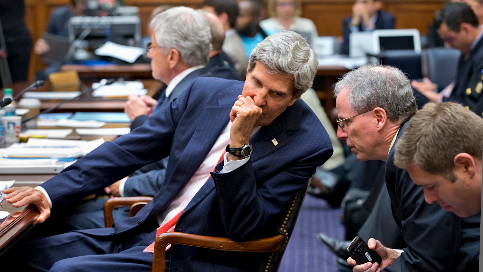 Secretary of State John Kerry confers with U.S. Ambassador to Syria Robert Ford, right, on Capitol Hill in Washington, Wednesday, Sept. 4, 2013.