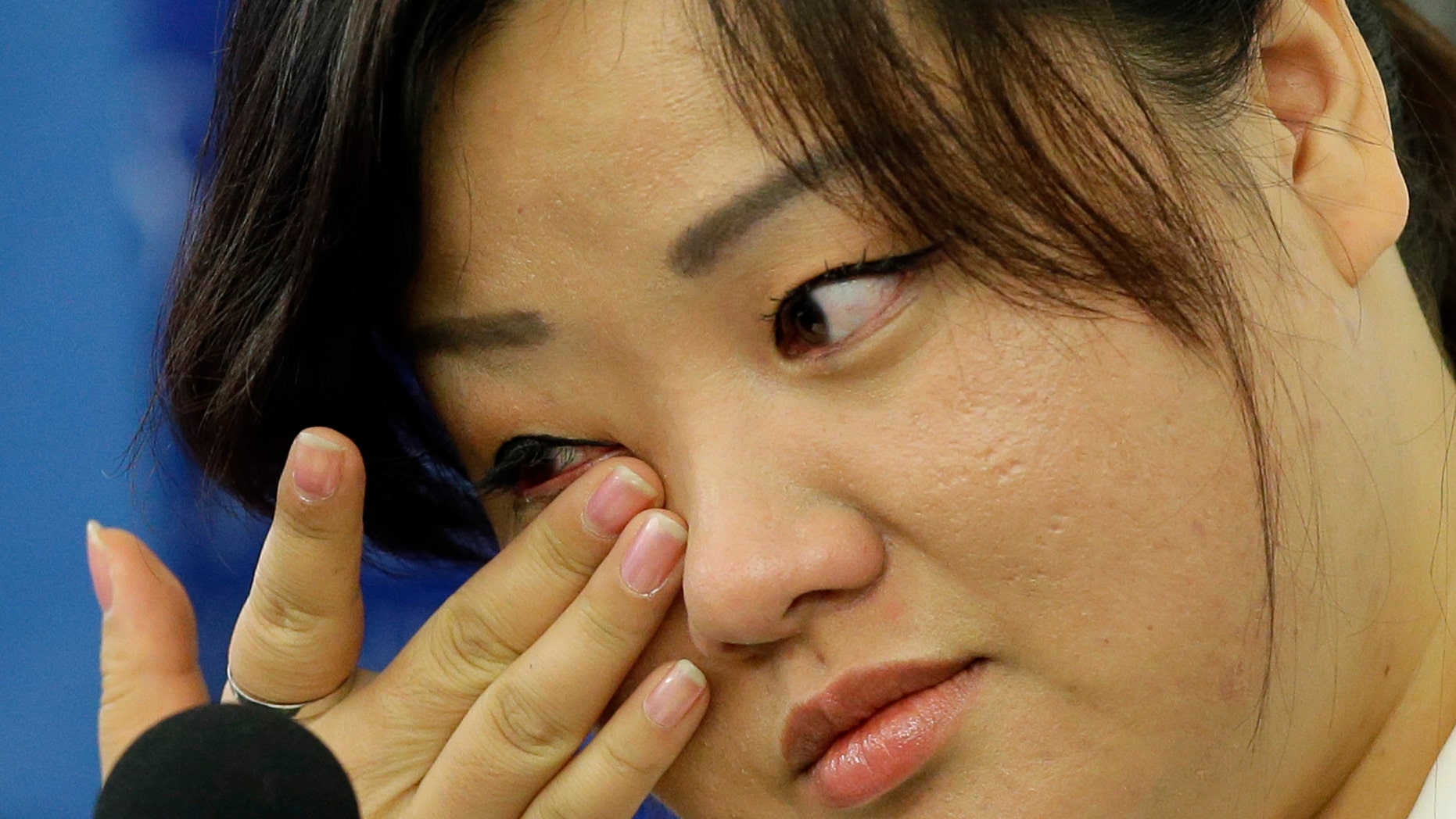 Oct. 30, 2013 - FILE photo of Jin hye Jo wiping a tear as she testifies in Washington D.C. during a hearing of the UN-mandated Commission of Inquiry about human rights in North Korea. Her father was tortured in detention in North Korea and died. Her elder sister went searching for food during the great famine of the 1990s, only to be trafficked to China. Her two younger brothers died of starvation, one of them a baby without milk whose life ebbed away in her arms.