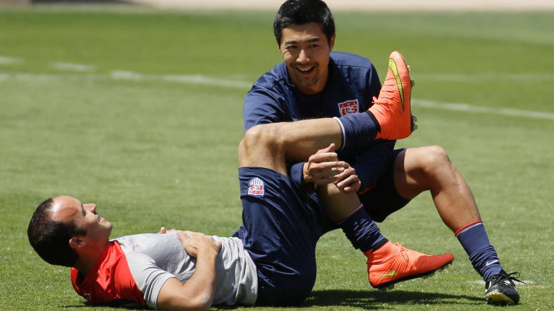 United States forward Landon Donovan stretches with assistance from a trainer in preparation for the World Cup soccer tournament on Thursday, May 22, 2014, in Stanford, Calif. (AP Photo/Ben Margot)