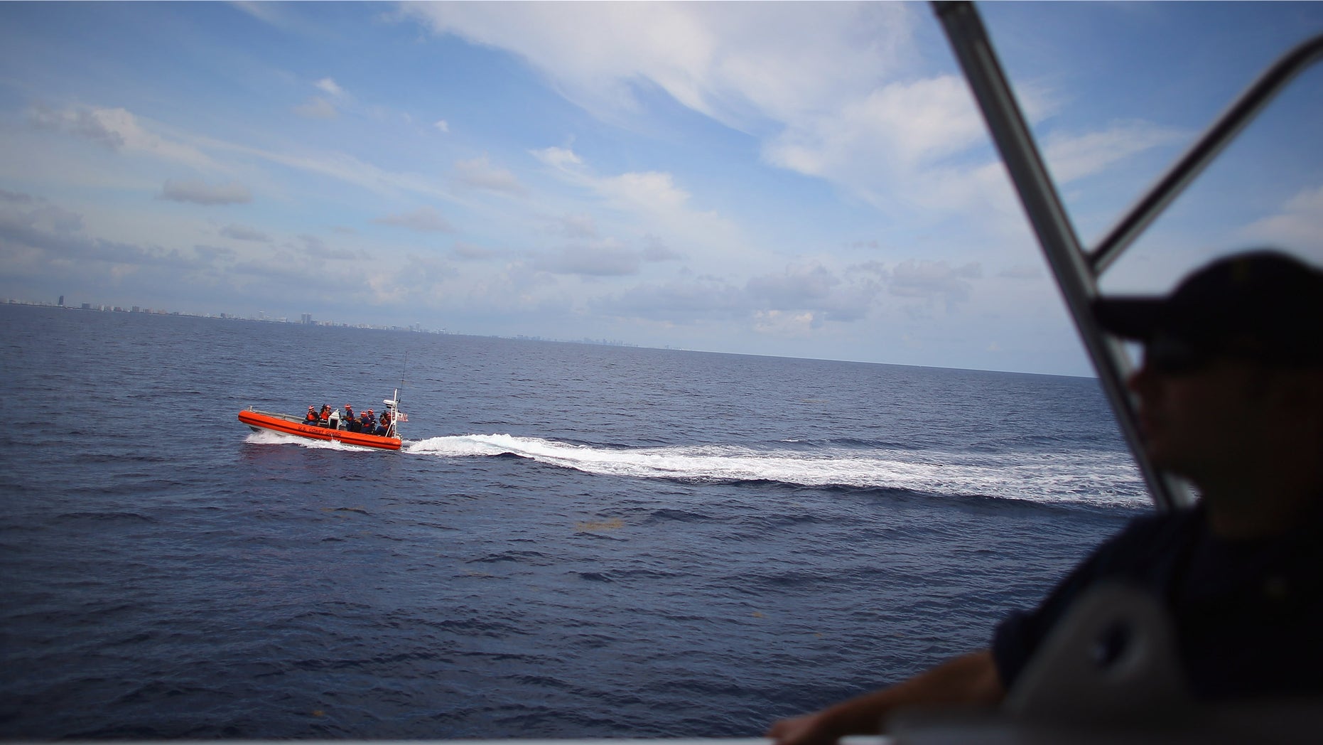 MIAMI BEACH, FL - OCTOBER 17: The 7.9-meter small boat moves past the United States Coast Guard Cutter William Flores after it was launched from the launch ramp on the back of the ship on October 17, 2012 just off shore Miami Beach, Florida. The cutter is the third of a planned 58 Fast Response Cutters in the Sentinel Class as the U.S. Coast Guard continues to replace its aging fleet. On November 3, the USCGC William Flores will be commissioned into service in Tampa, Florida. (Photo by Joe Raedle/Getty Images)