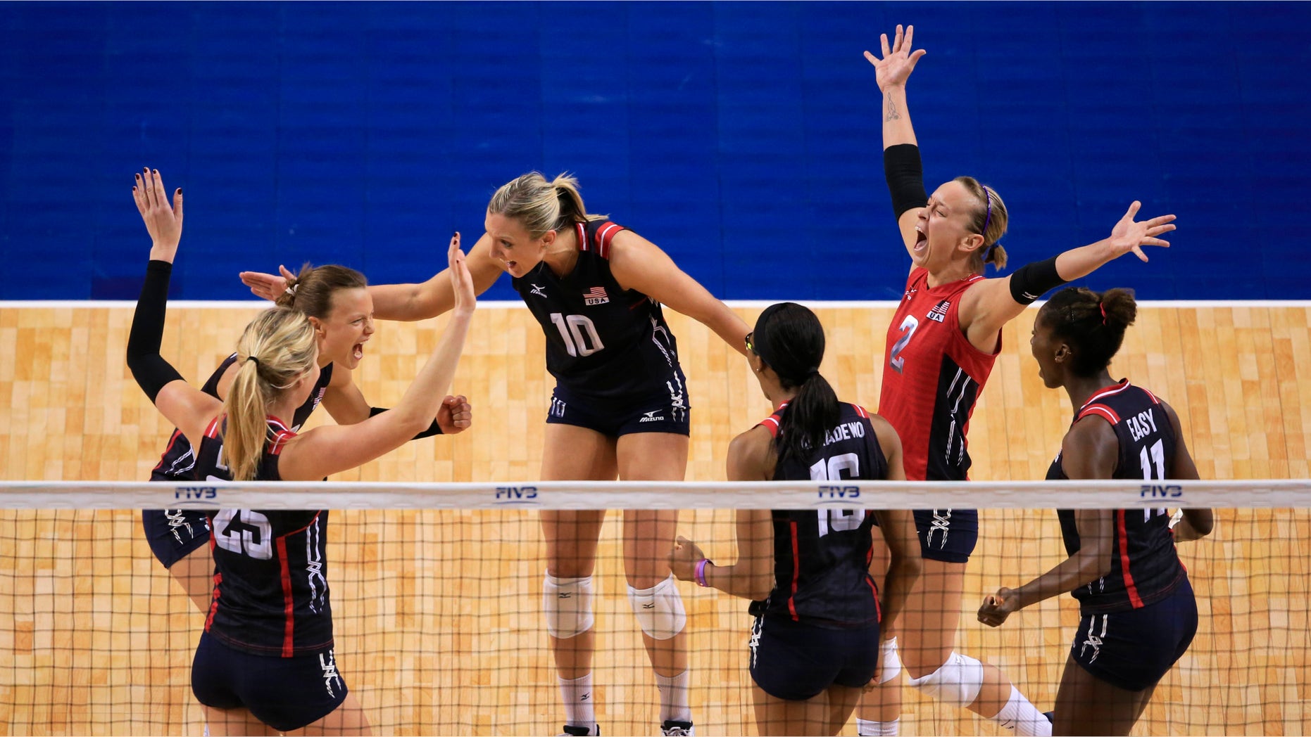 United States' Courtney Thompson, back left, Jordan Larson-Burbach (10), Kayla Banwarth (2) and others celebrate a point against the Dominican Republic in a women's volleyball NORCECA round-robin Olympic qualifying tournament match in Lincoln, Neb., Saturday, Jan. 9, 2016. (AP Photo/Nati Harnik)