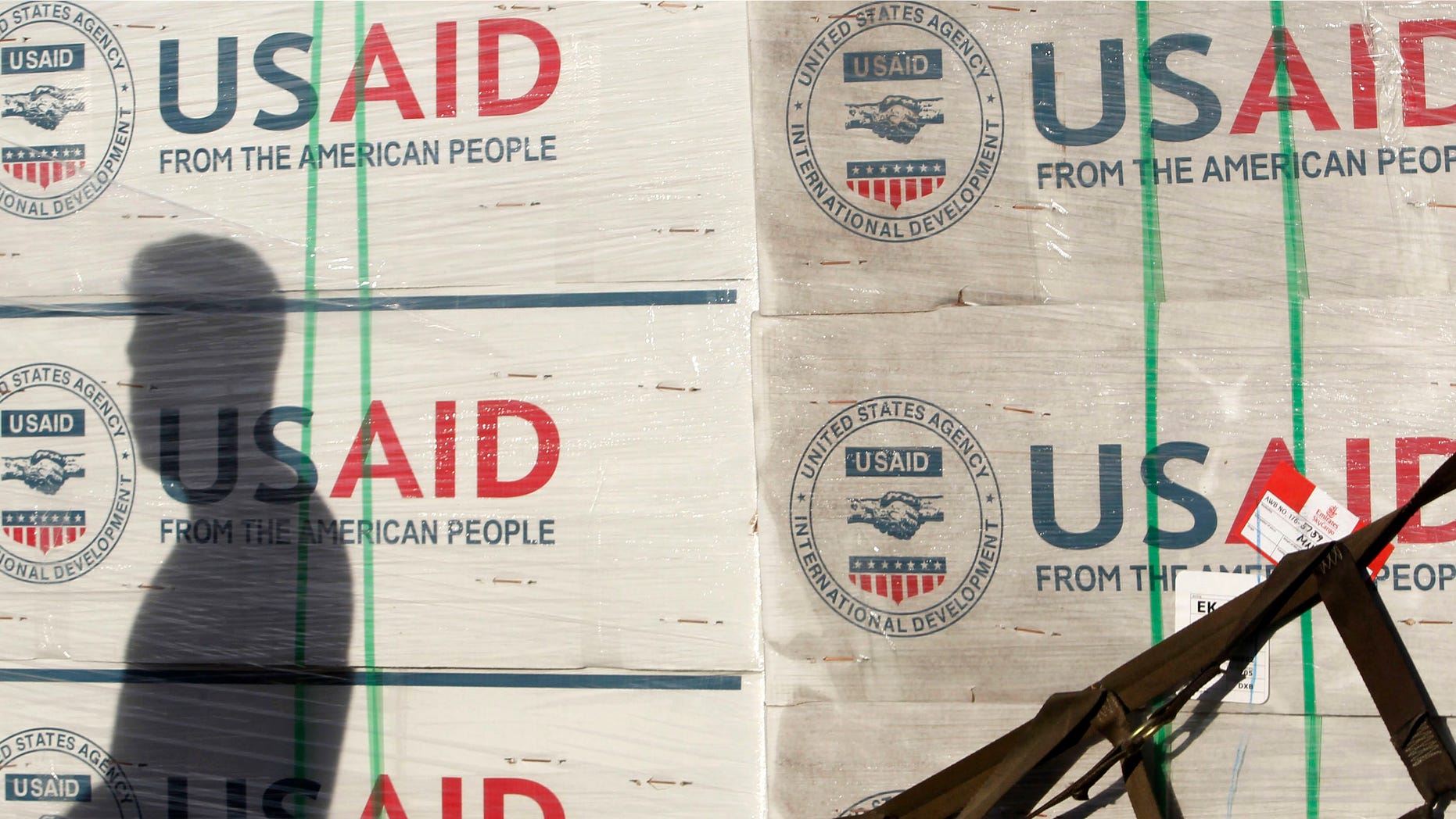 A shadow is cast on boxes of relief items from U.S. Agency for International Development (USAID).