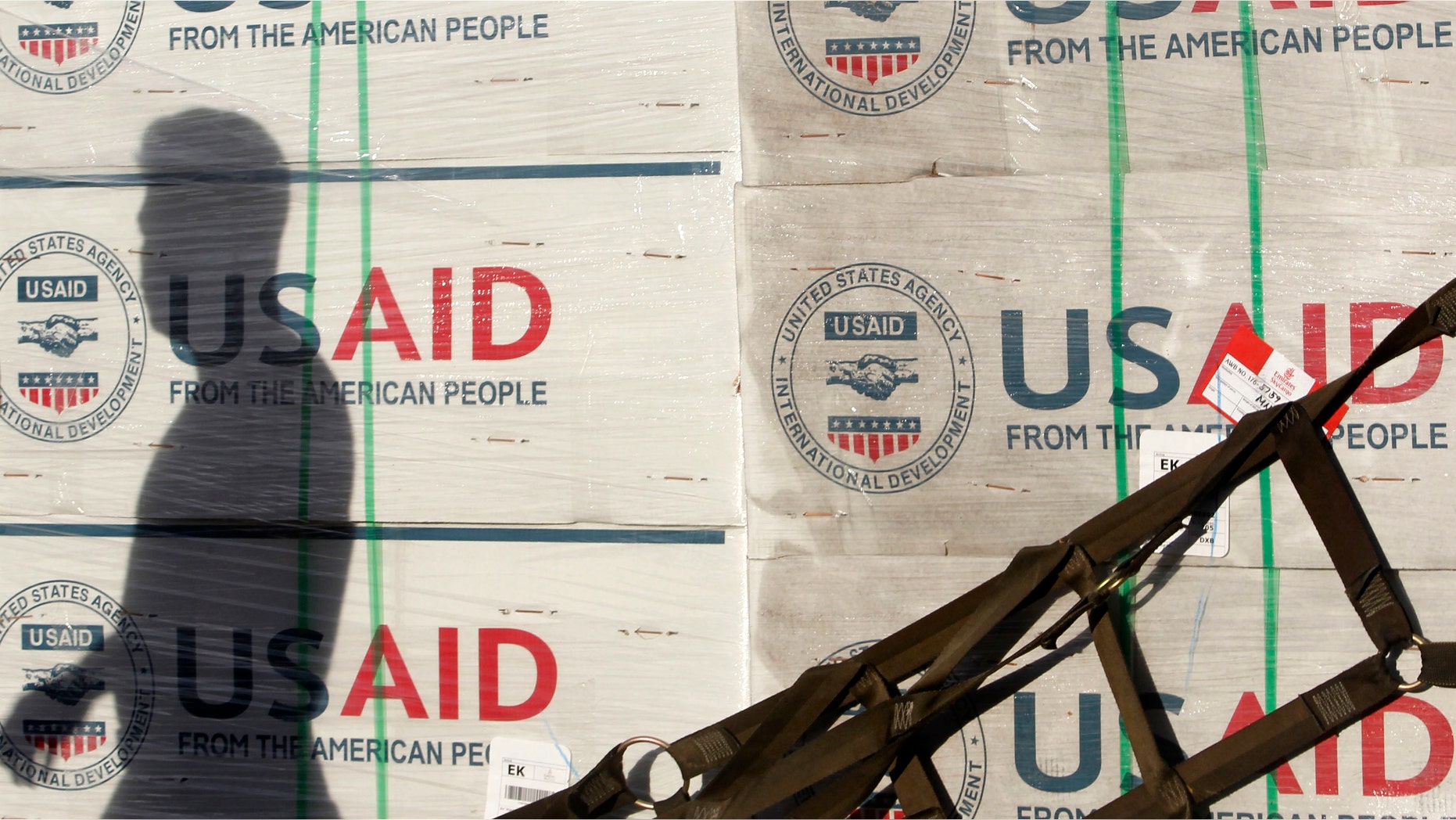 The shadow of a Philippine Army personnel is cast on boxes of relief items from U.S. Agency for International Development (USAID) for the victims of super typhoon Haiyan, at Villamor Air Base in Manila November 13, 2013.