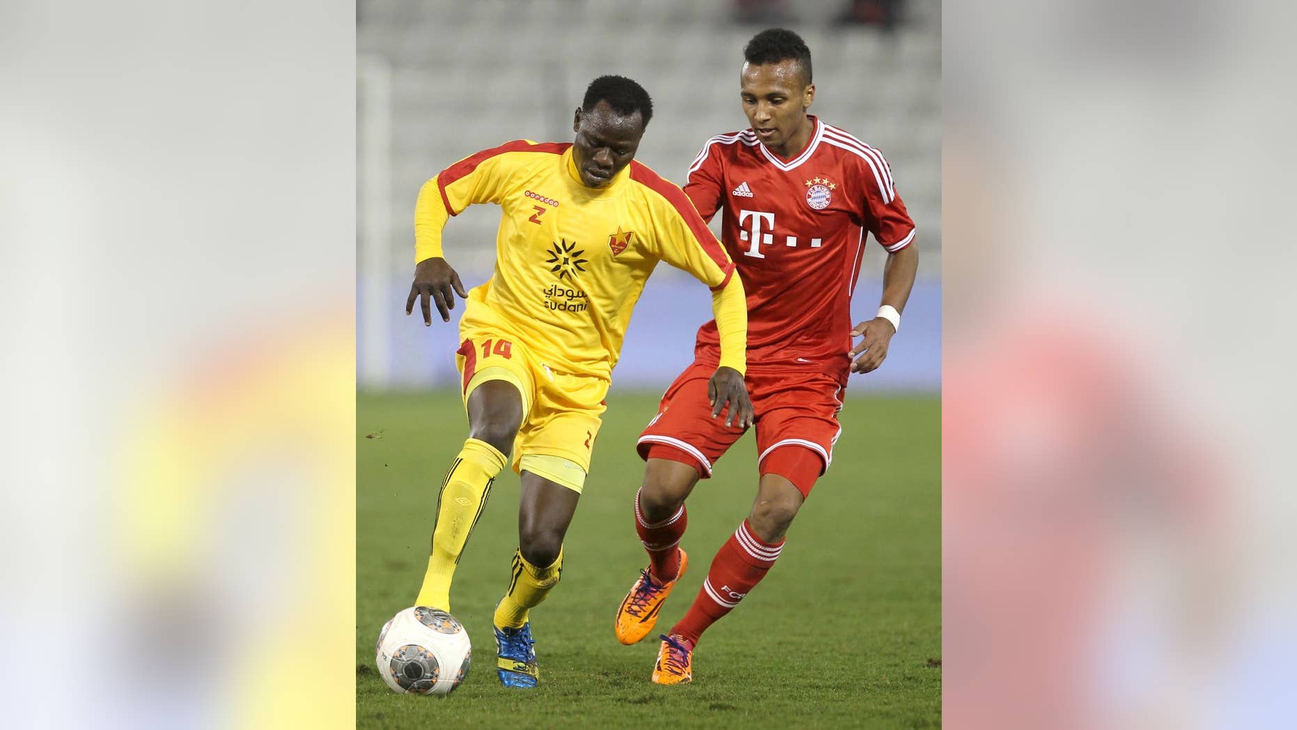 FILE - In this Jan. 9, 2014, file photo, Bayern Munich's Julian Green, right, of Munich, and Balla Jabir, of Al-Merrikh, challenge for the ball, during their friendly soccer match, at Al-Saad stadium in Doha. Green has joined the U.S. soccer team, a glistening talent still developing, a youngster who grew up in Germany with regular trips to see his father in Florida. He will make his debut for the United States against Mexico on Wednesday, April 2. (AP Photo/Osama Faisal, File)