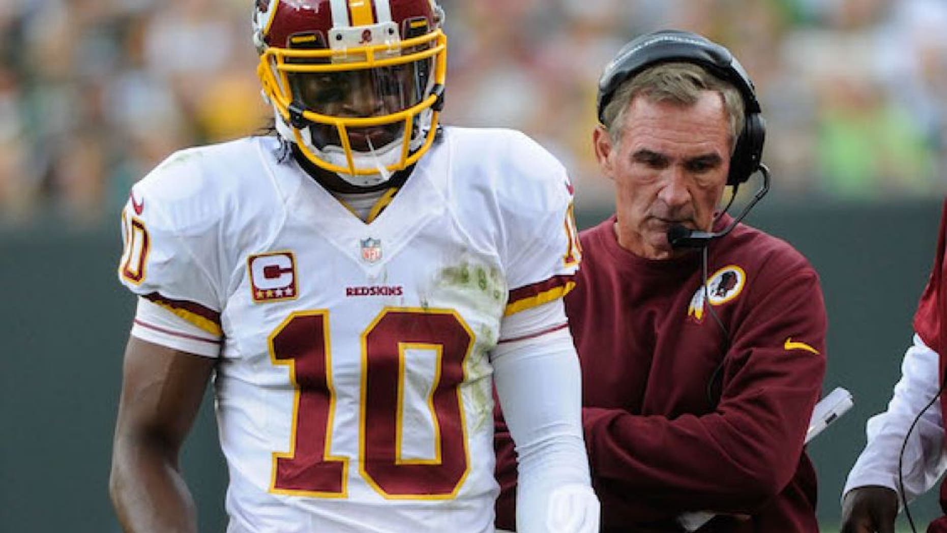Sep 15, 2013; Green Bay, WI, USA; Washington Redskins quarterback Robert Griffin III (10) and head coach Mike Shanahan walk on the sidelines during the game against the Green Bay Packers in the third quarter at Lambeau Field. Mandatory Credit: Benny Sieu-USA TODAY Sports
