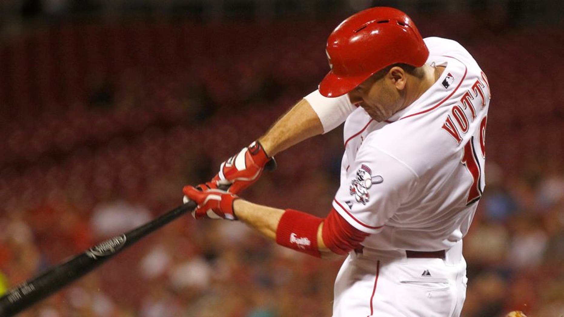 Aug 19, 2015; Cincinnati, OH, USA; Cincinnati Reds first baseman Joey Votto hits a solo home run against the Kansas City Royals in the first inning at Great American Ball Park. Mandatory Credit: David Kohl-USA TODAY Sports
