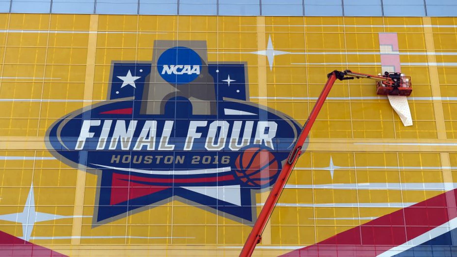 Mar 28, 2016; Houston, TX, USA; A worker applies signage to the side of NRG Stadium in preparations for the 2016 NCAA Men's Final Four Championship. Mandatory Credit: Bob Deutsch-USA TODAY Sports