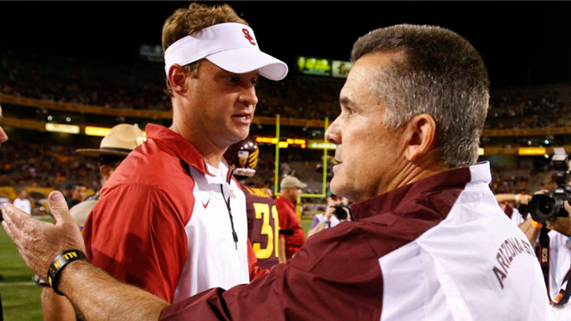 Sept. 28, 2013: Southern California head coach Lane Kiffin shakes hands with Arizona State head coach Todd Graham after an NCAA college football game in Tempe, Ariz.