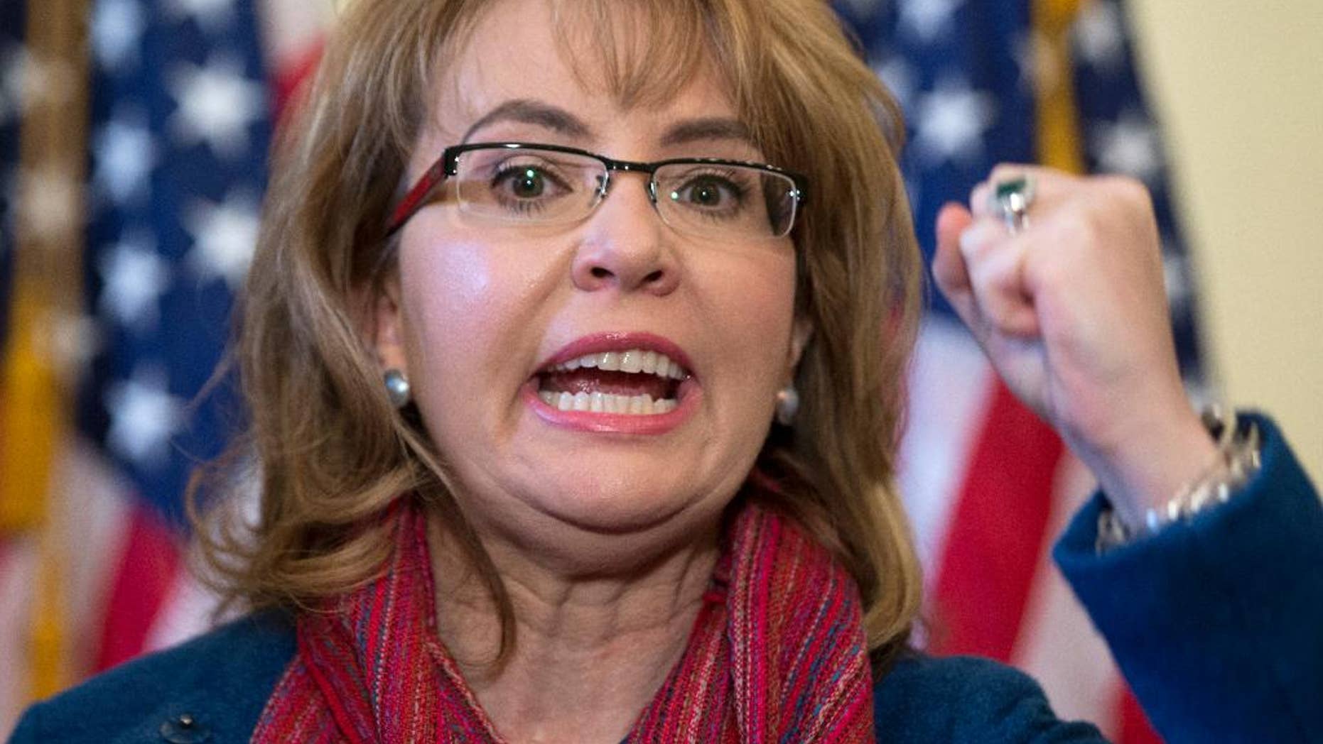 FILE - In this March 4, 2015, file photo, former U.S. Rep. Gabrielle "Gabby" Giffords of Arizona gestures as she speaks on Capitol Hill in Washington. Giffords is being recognized with a Navy ship named in her honor at a shipyard in Mobile, Alabama. Giffords is set to attend the Saturday, June 13, 2015, christening of the USS Gabrielle Giffords. (AP Photo/Carolyn Kaster, File)