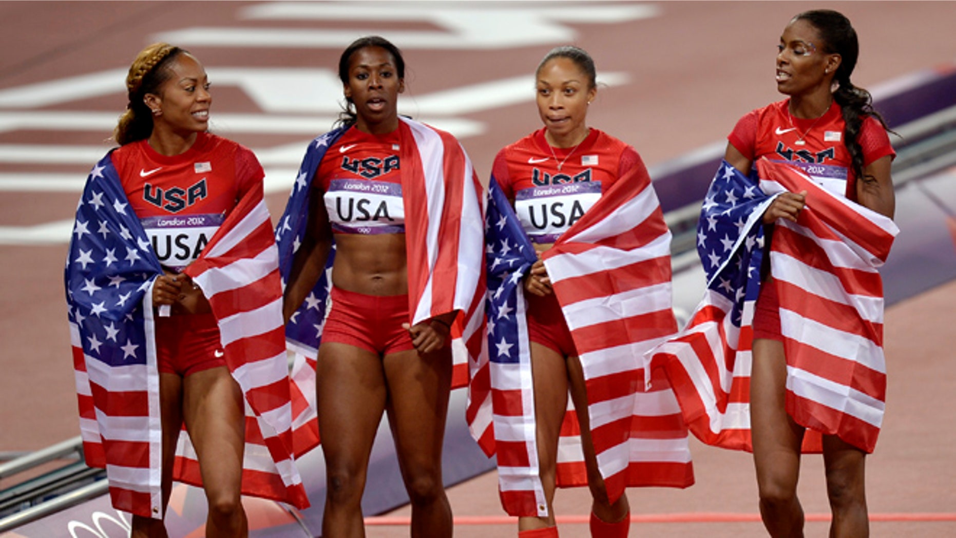 Aug. 11, 2012: United States' women's relay team members from left, Sanya Richards-Ross, Francena McCorory, Allyson Felix, and Deedee Trotter wear their national flag after their gold medal win in the 4 x 400-meter relay during the athletics in the Olympic Stadium at the 2012 Summer Olympics, London.