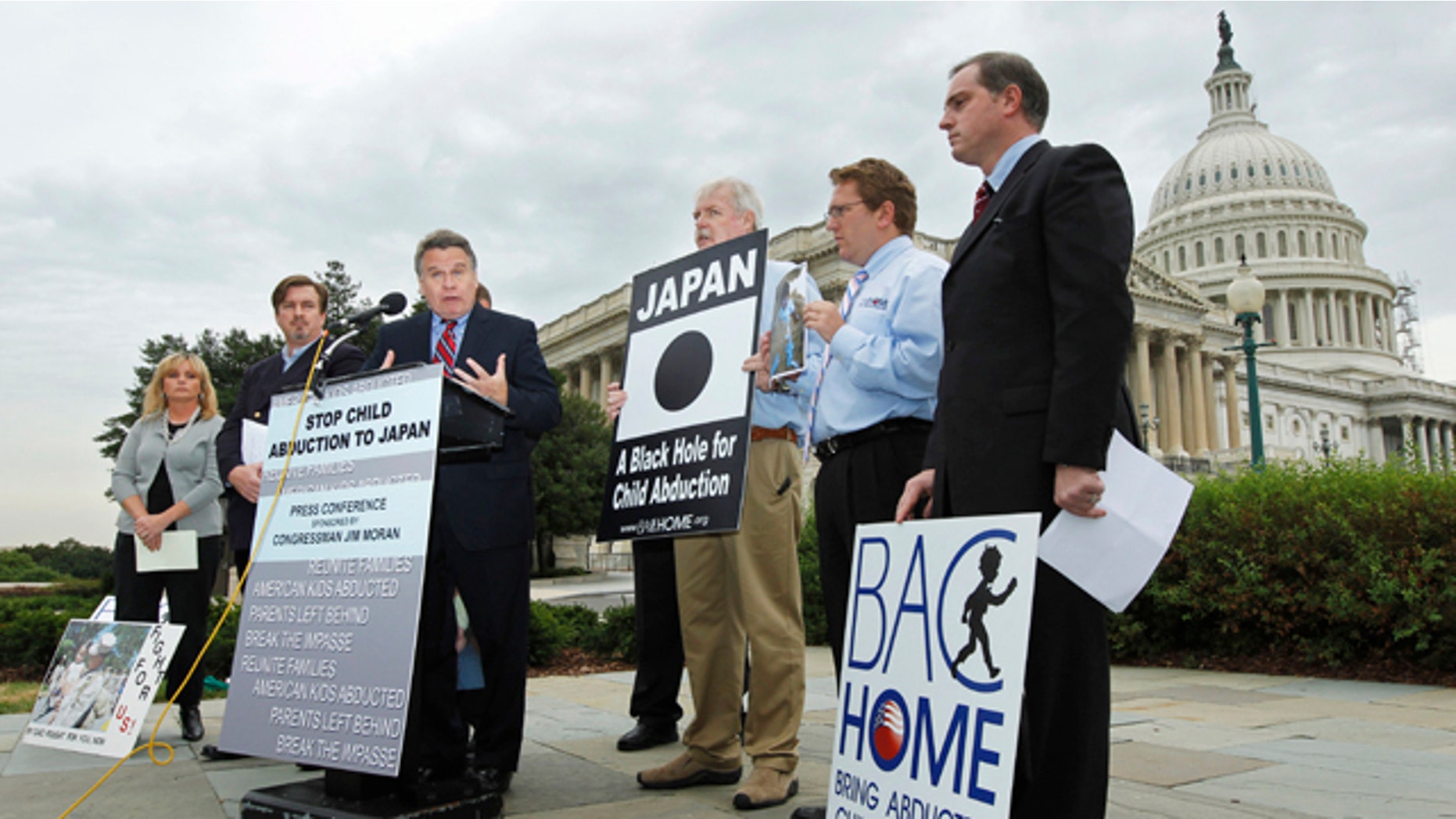 Sept. 29, 2010: In this file photo, Rep. Chris Smith, center, R-N.J. with relatives of American children abducted to Japan, speaks at a news conference on Capitol Hill in Washington, calling for swift passage of a resolution on child abduction to Japan. Japan has taken the first step toward joining an international child custody convention Thursday, May 19, 2011 amid foreign pressure on Tokyo to revise a policy some say allows Japanese mothers to too easily take their children away from foreign fathers.