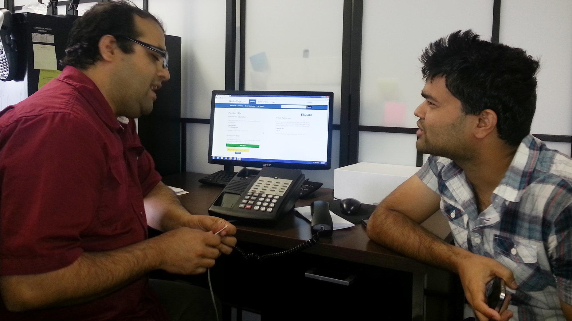 This photo taken Friday, Aug. 29, 2014 and made available by Amy Jones, shows Shekhar Bastola, a SEAMAAC Bhutanese outreach worker, left, assisiting Bhagawat Bastola with his immigration documents in Philadelphia. Bastola is helping Bastola with the status of his immigration documents submitted to purchase health insurance under the Affordable Care Act. More than 300,000 immigrants who bought insurance through President Barack Obamas health care initiative could lose their coverage this month if they dont submit proof this week they are legally in the country, but language barriers and computer glitches are hindering efforts to alert them. (AP Photo/SEAMAAC, Amy Jones)