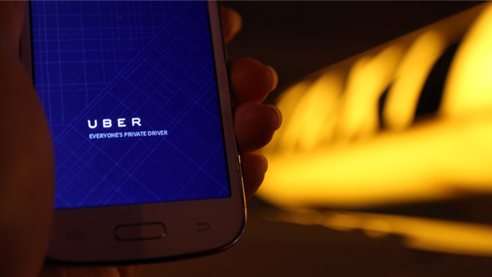 BERLIN, GERMANY - SEPTEMBER 02: In this photo illustration, a woman uses the Uber app on an Samsung smartphone on September 2, 2014 in Berlin, Germany. Uber, an app that allows passenger to buy rides from drivers who do not have taxi permits, has had its UberPop freelance driver service banned in Germany after a complaint by Taxi Deutschland, a trade association of taxi drivers in the country. The company, which operates in 42 countries over 200 cities worldwide, plans to both appeal the decision made by a court in Frankfurt as well as, at the risk of heavy fines, continue its services in Germany until a final decision has been made on the matter. (Photo by Adam Berry/Getty Images)