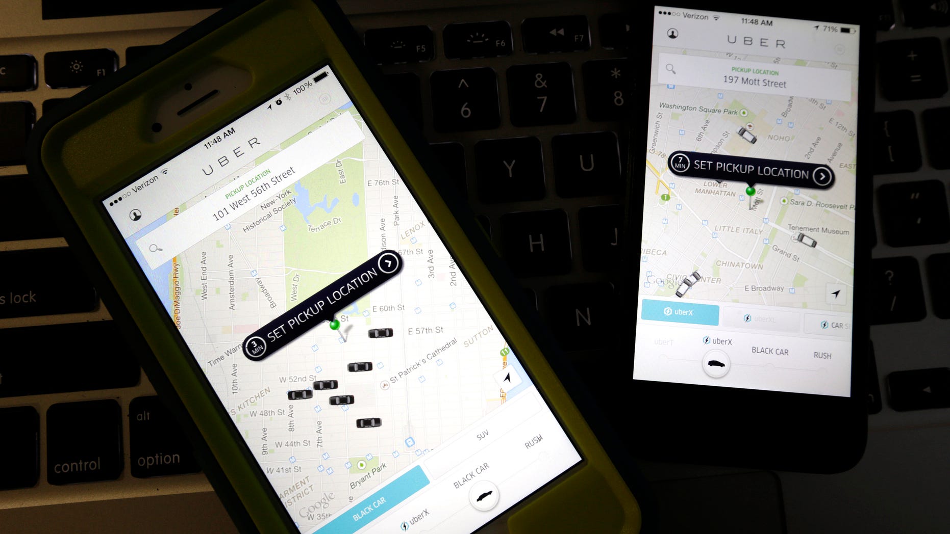 Smartphones display Uber car availability in New York.