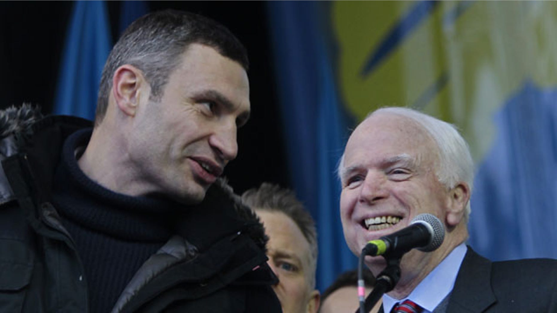 December 15, 2013: Ukrainian lawmaker and chairman of the Ukrainian opposition party Udar (Punch), WBC heavyweight boxing champion Vitali Klitschko, left, speaks to U.S. Senator John McCain during a pro-European Union rally in Independence Square in Kiev, Ukraine. (AP Photo)