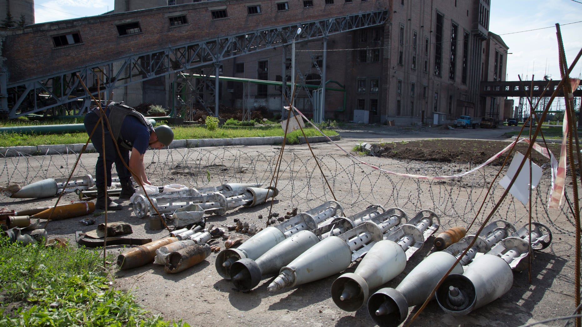 July 10, 2014 - A member of the rescue service works near fragments of a multiple missile "Smerch" found after an attack by Ukrainian government forces at a power station outside the city of Slovyansk, Donetsk Region, eastern Ukraine. In the past two weeks, Ukrainian government troops have halved the amount of territory held by the rebels.