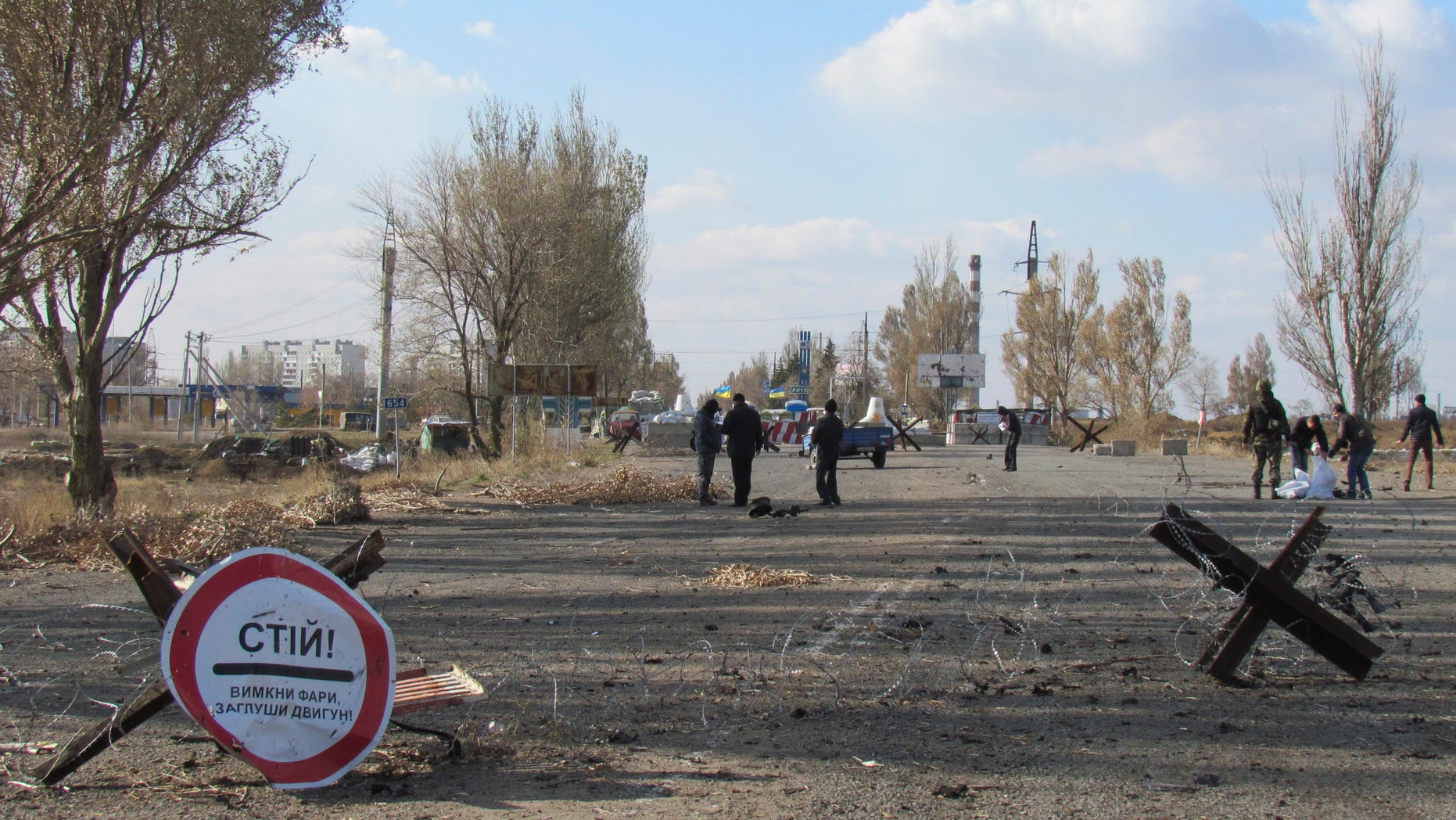 November 2, 2014 - Investigators at site of a car explosion at a Ukraine-held checkpoint on the outskirts of Mariupol, The blast killed 2 and injured 1 Ukrainian servicemen, according to Andriy Lysenko, Ukraine's National Security spokesman. Ukraine on Friday accused Russia of sending dozens of tanks and other heavy weapons into its rebel-controlled easternmost regions.