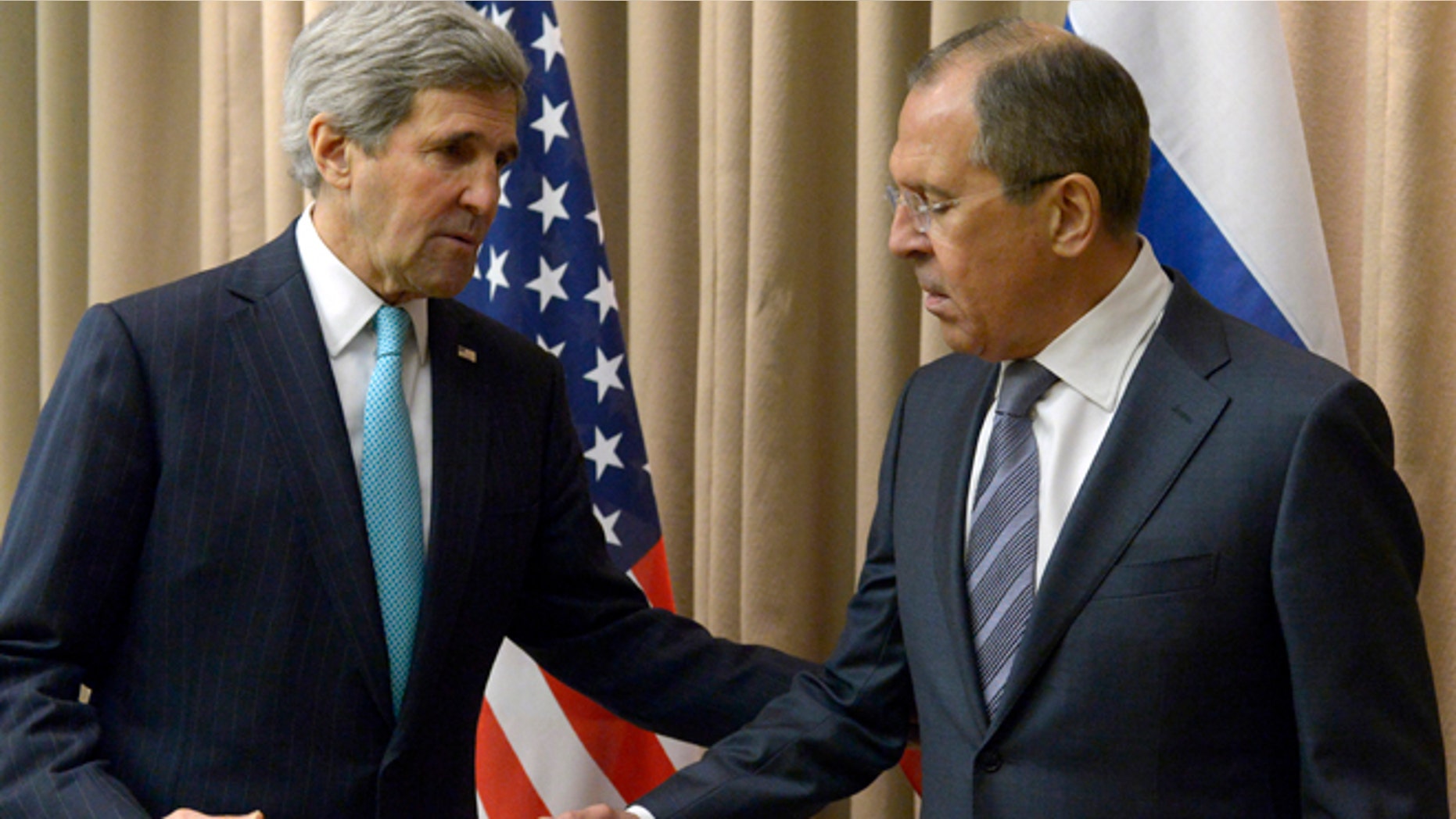 April 17, 2014: U.S. Secretary of State John Kerry, left, shakes hands with Russian Foreign Minister Sergey Lavrov before a bilateral meeting to discuss the ongoing situation in Ukraine as diplomats from the U.S., Ukraine, Russia and the European Union gather for discussions in Geneva.